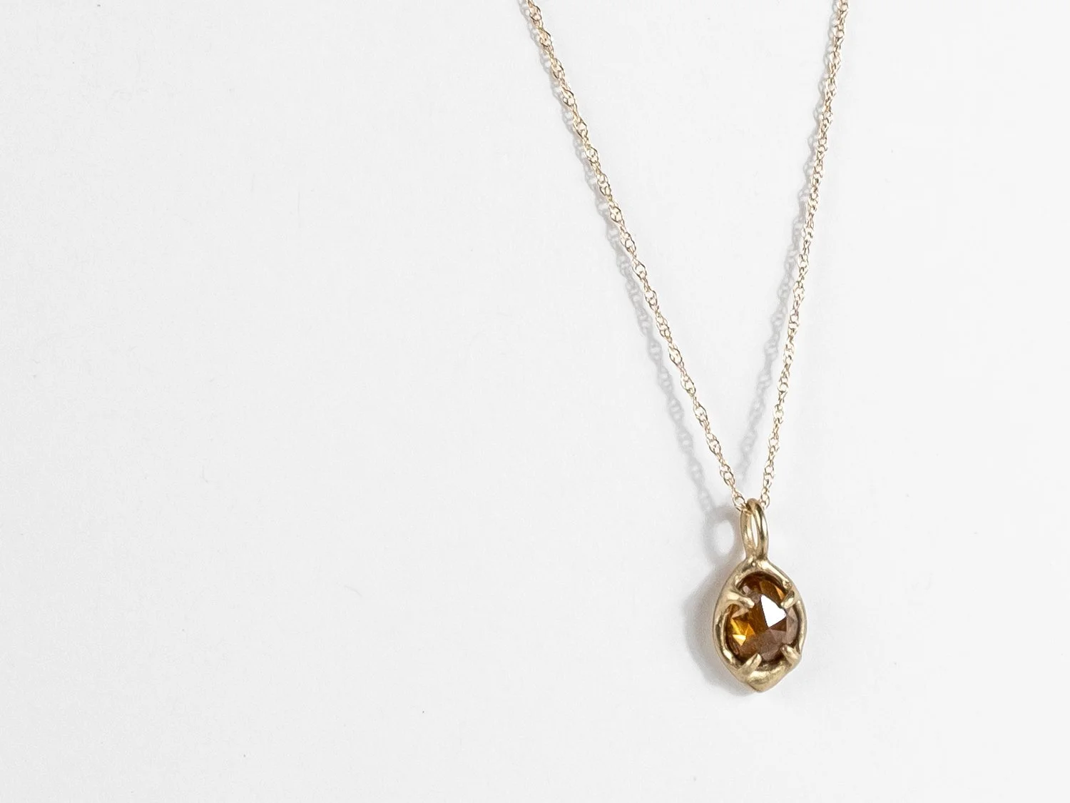 14k gold chain with a faceted stone charm