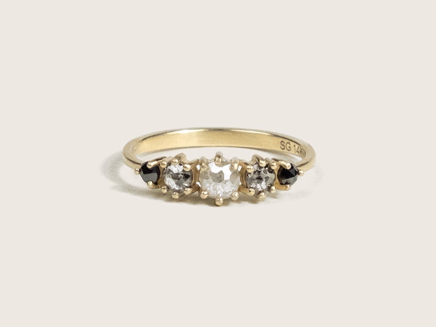 Gold ring with black, salt and pepper, and icy white diamonds