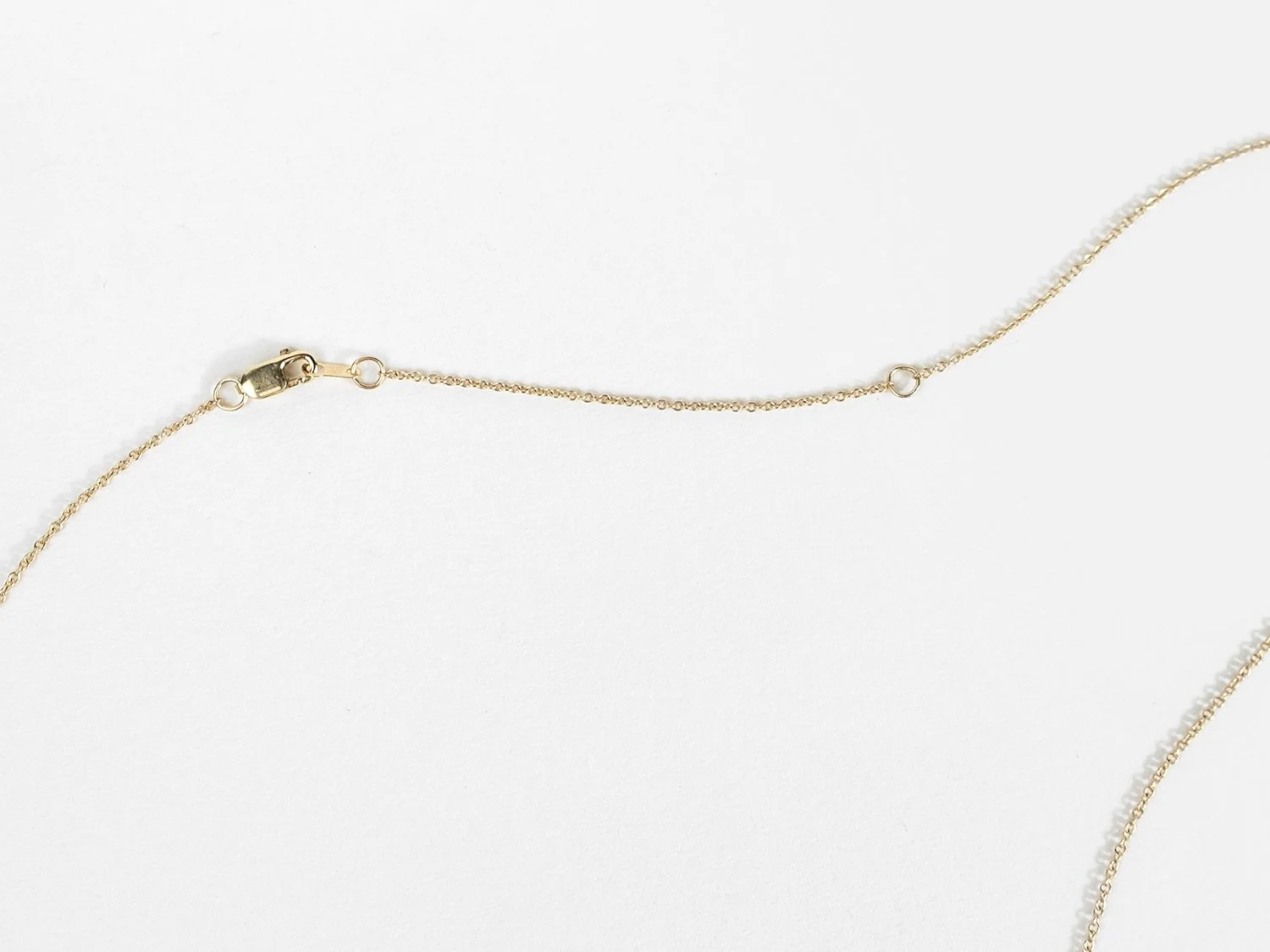 Lobster closure and chain on a 14k gold necklace
