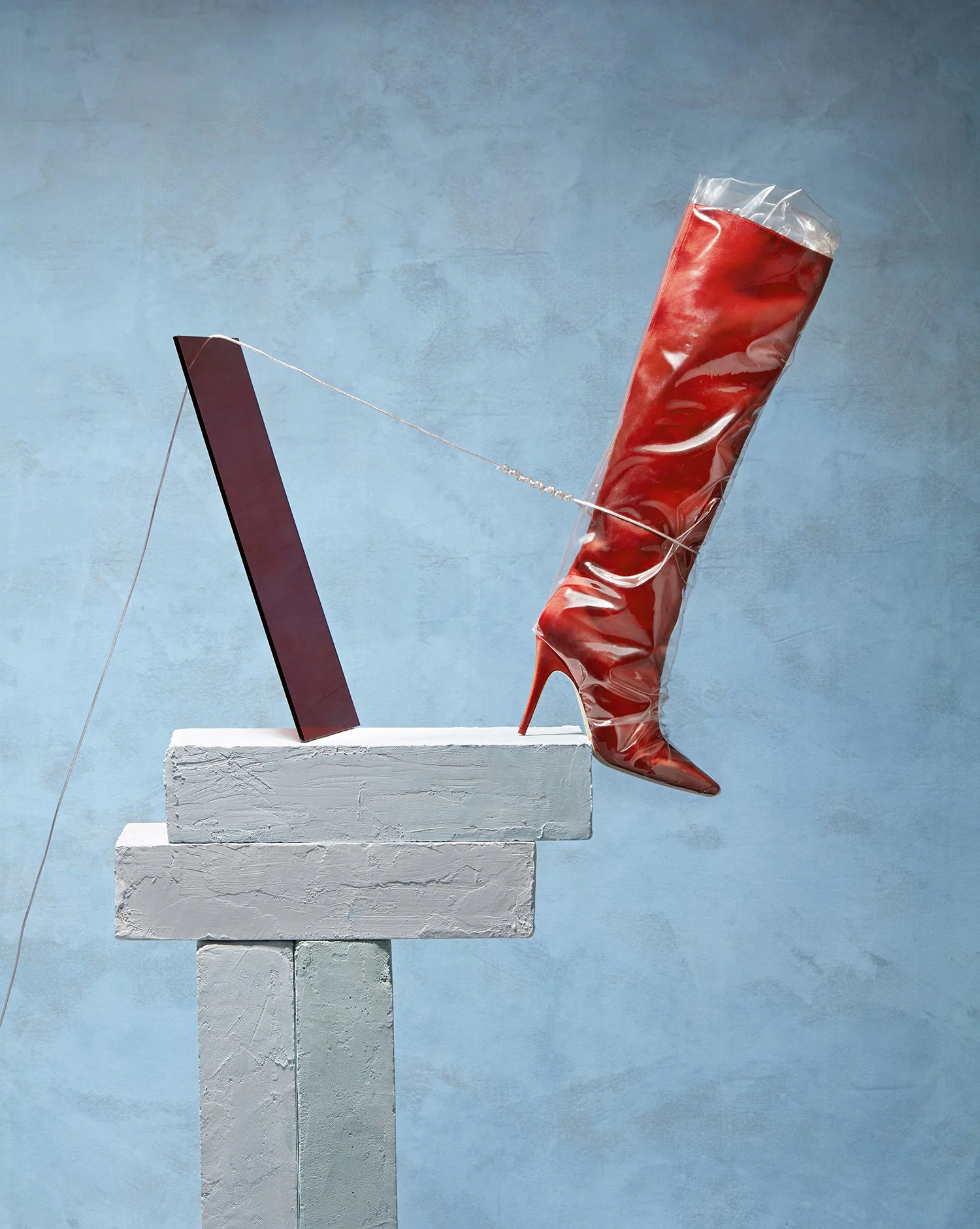 Set design still life with red Jimmy Choo boot