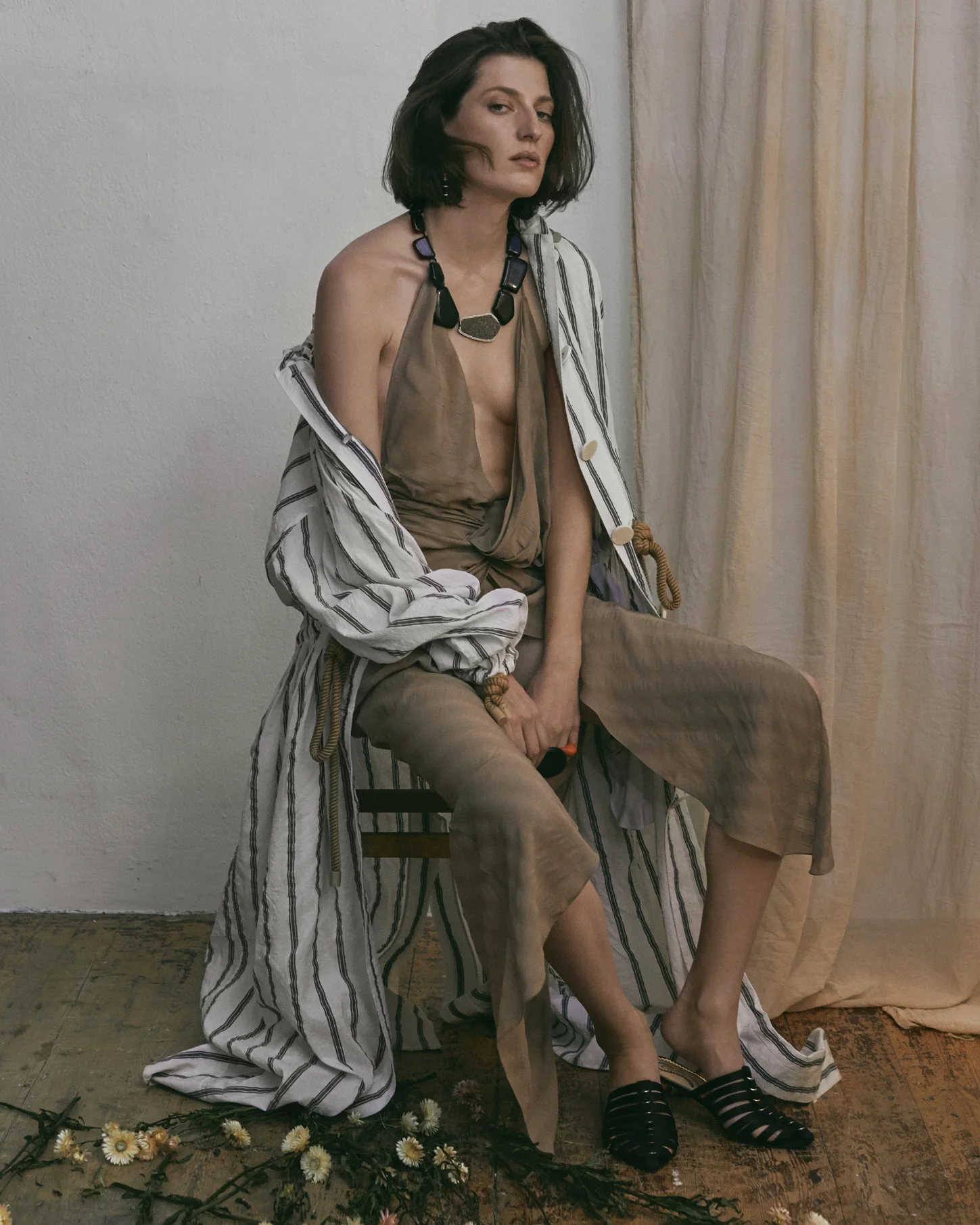 Sunday times set design - model sitting with fabric backdrop