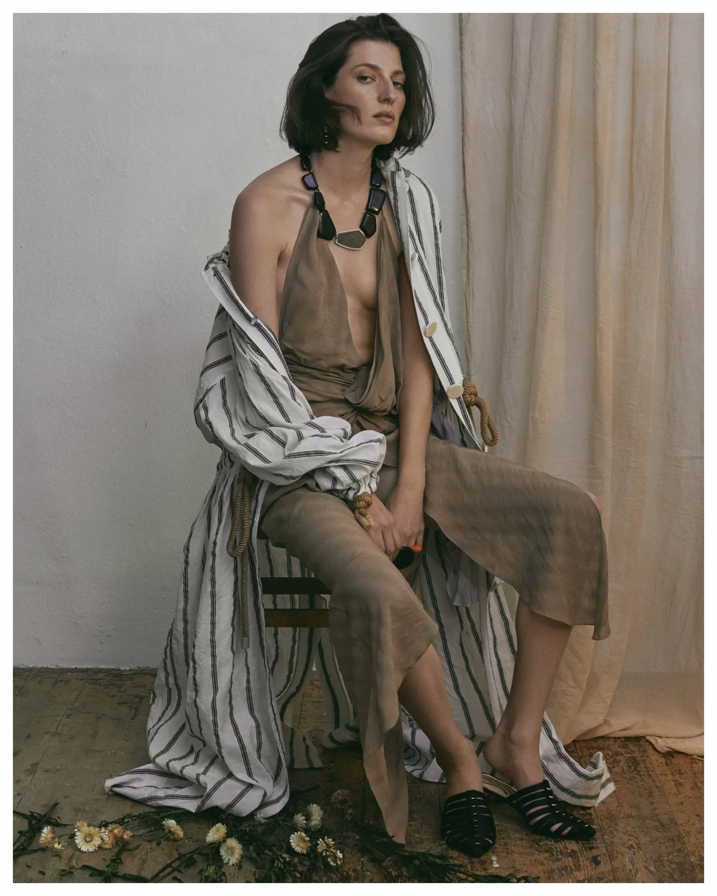 Sunday times set design - model sitting with fabric backdrop