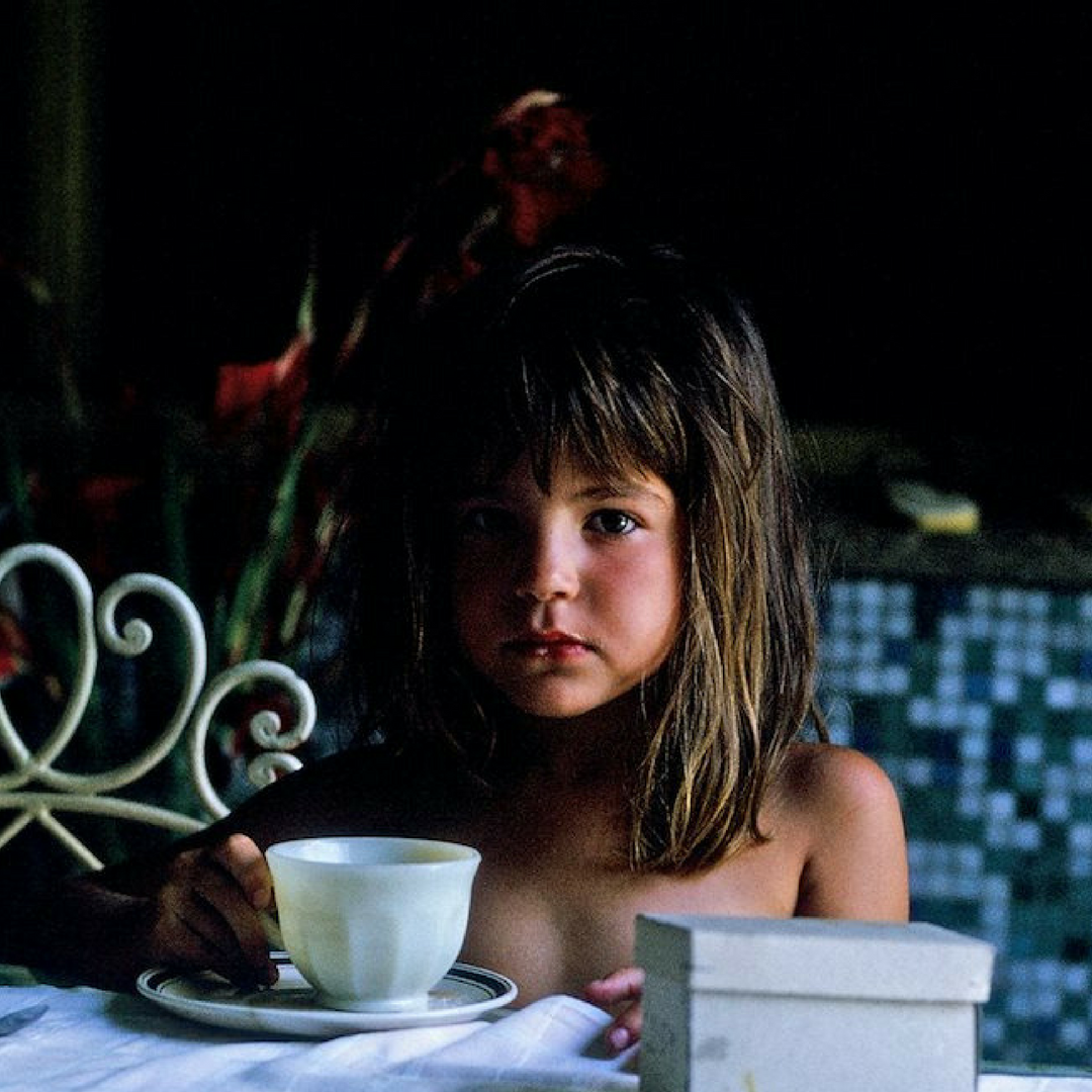 This is me as a child in Argentina at my grandmother's table in her "magical" backyard drinking mate.