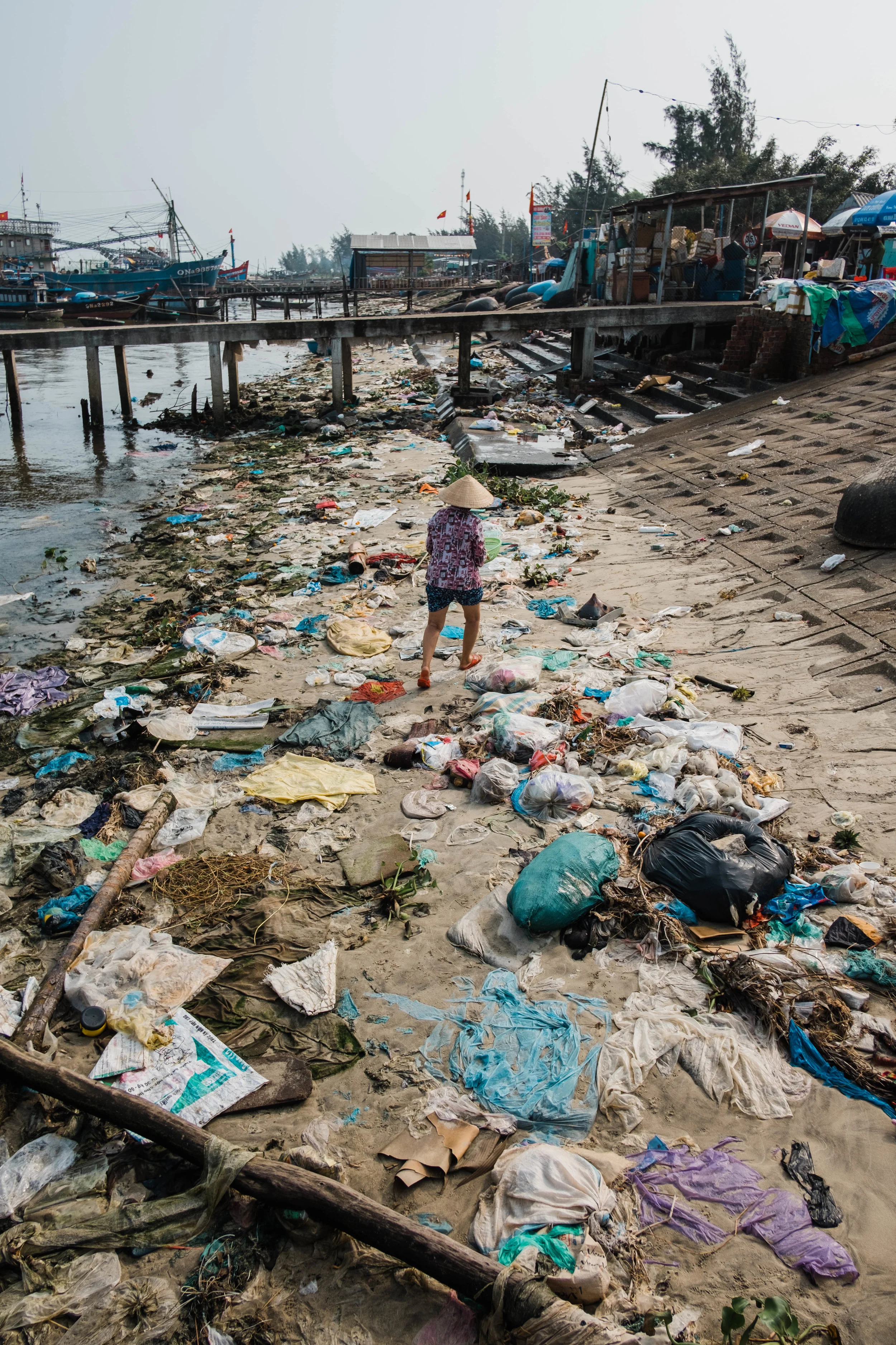 Woman walking towards the fishers’ market outside of Hoi An, Vietnam.