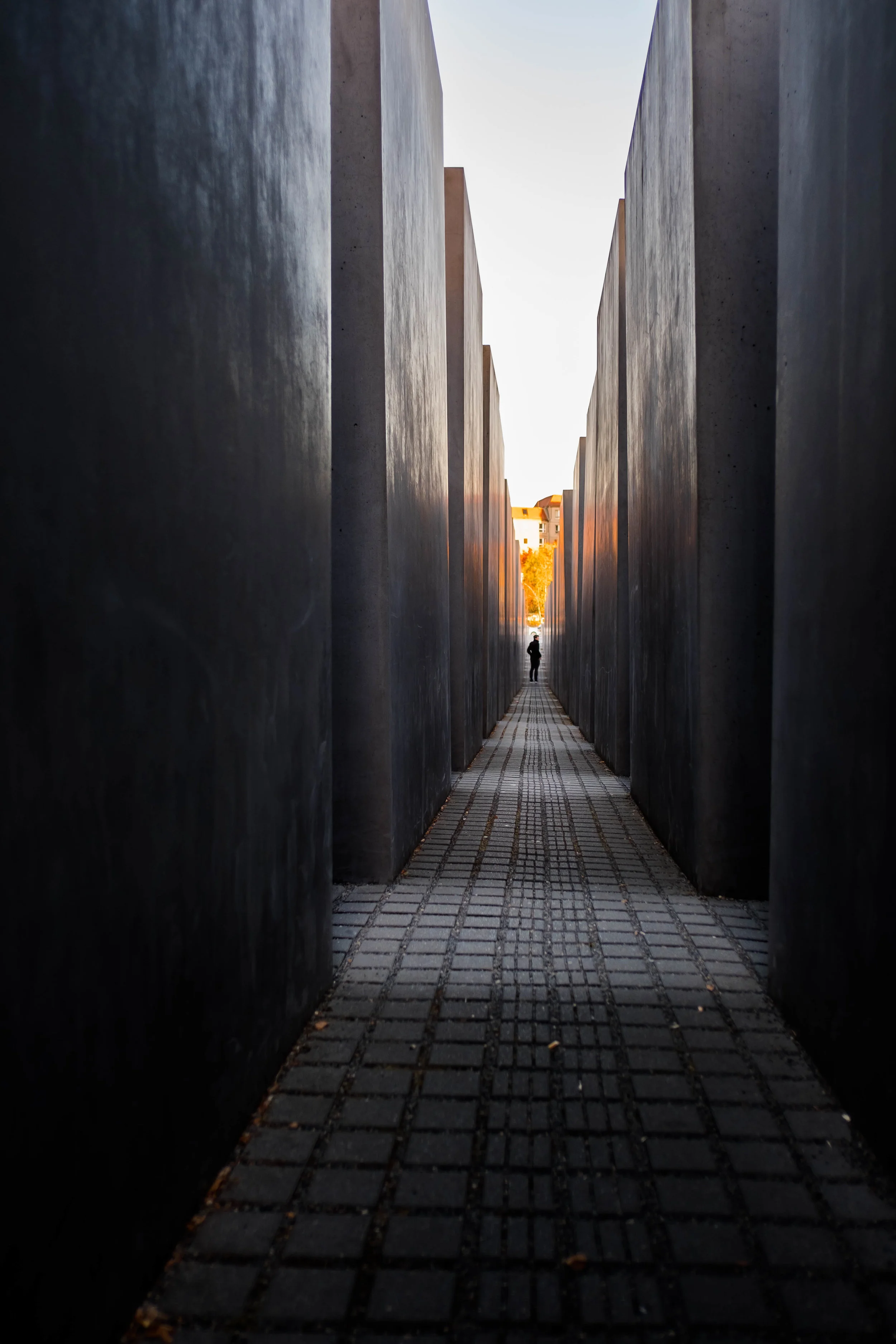 A lone man taking in the maze of concrete blocks at the Memorial to the Murdered Jews of Europe, Berlin, Germany.