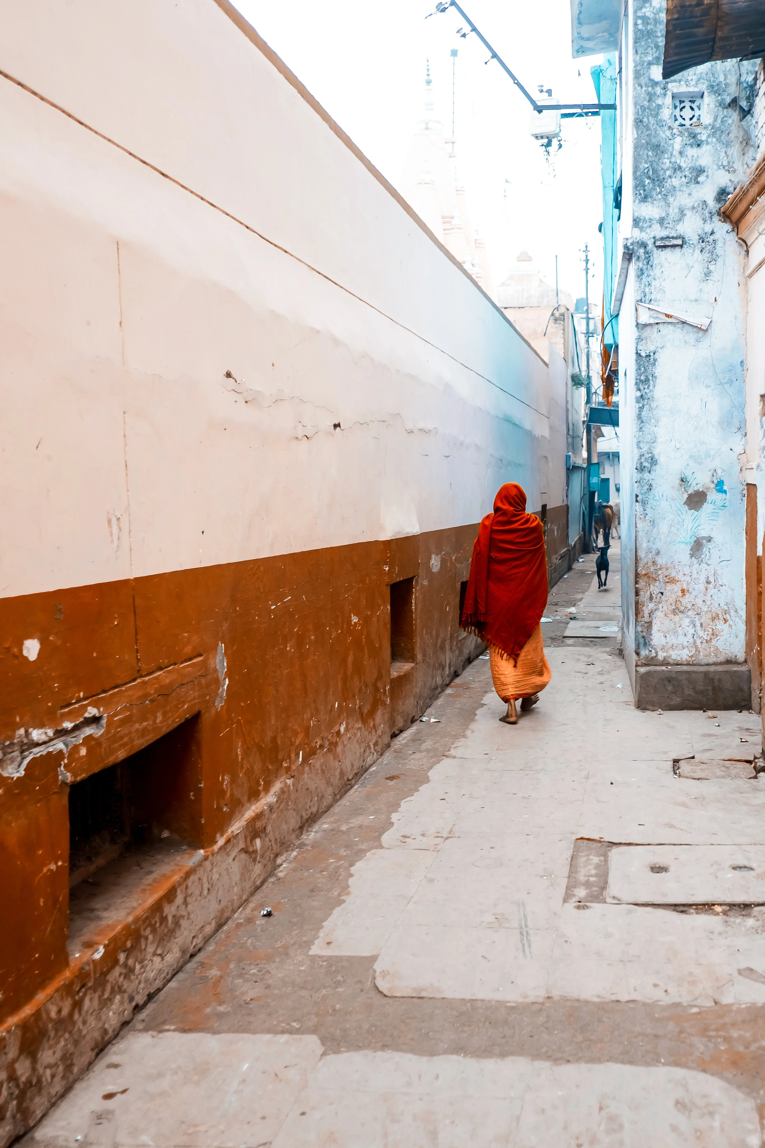Woman walks down the alley in Varanasi, India.