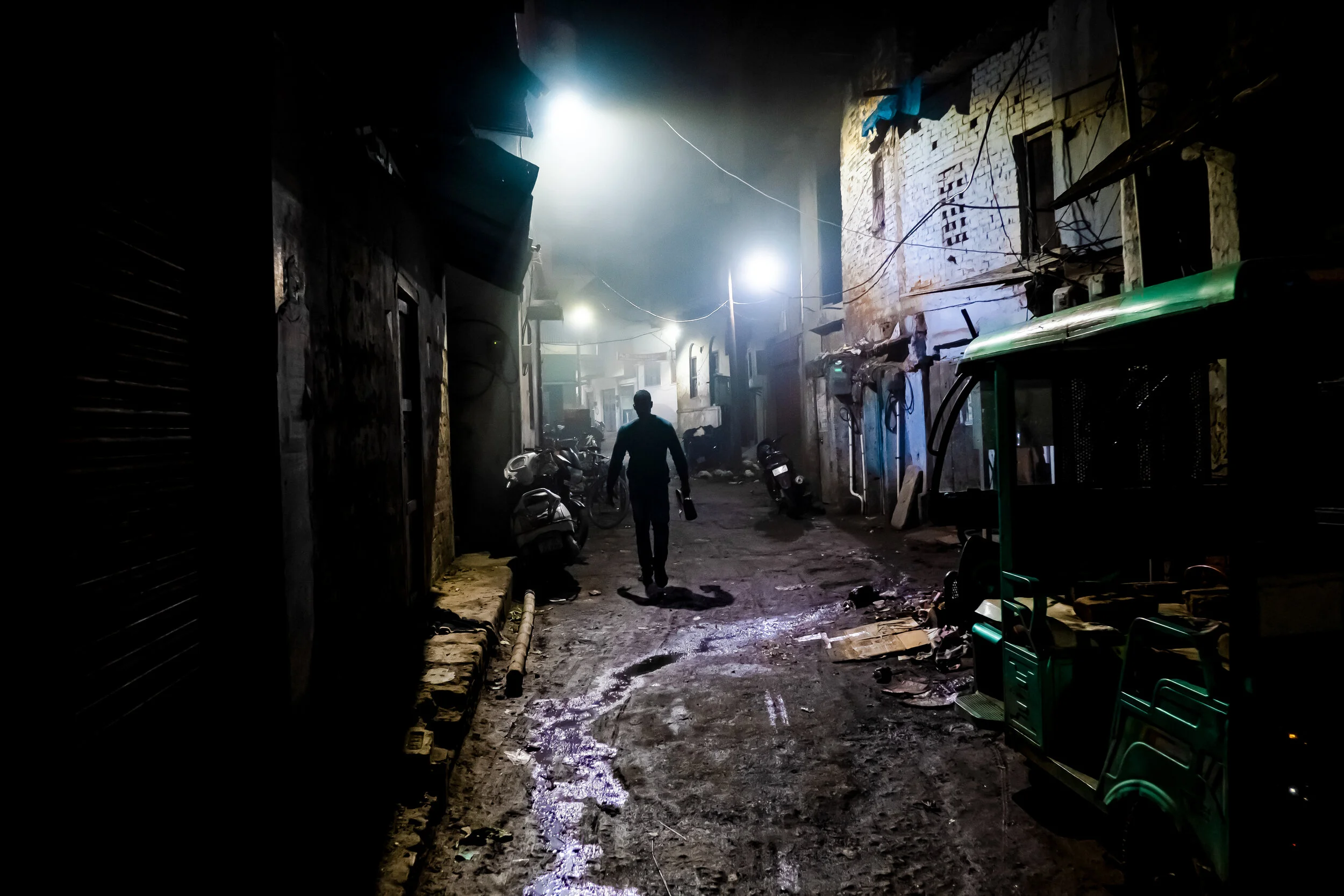 A tour guide walks ahead at dawn in Varanasi, India.