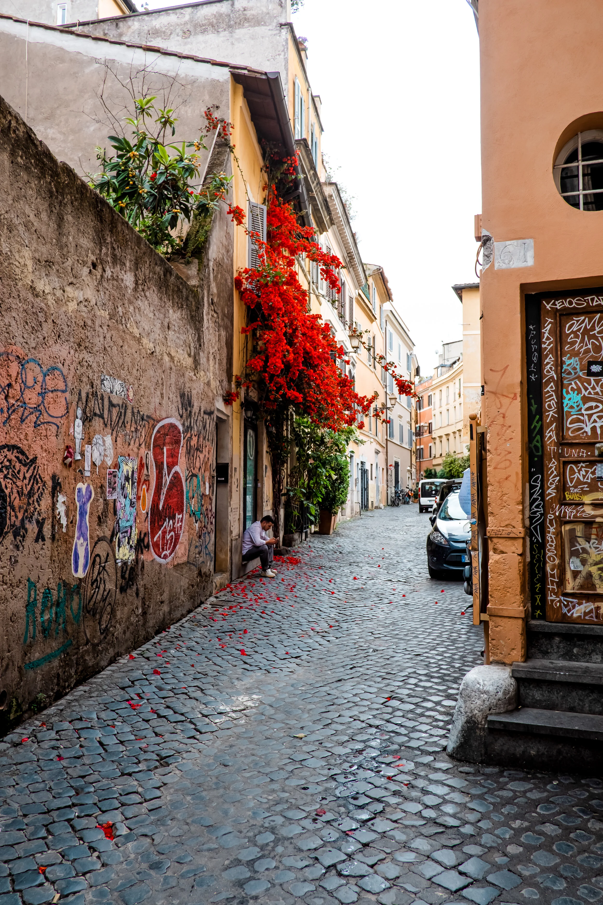 Man takes a moment on his phone in Rome, Italy.