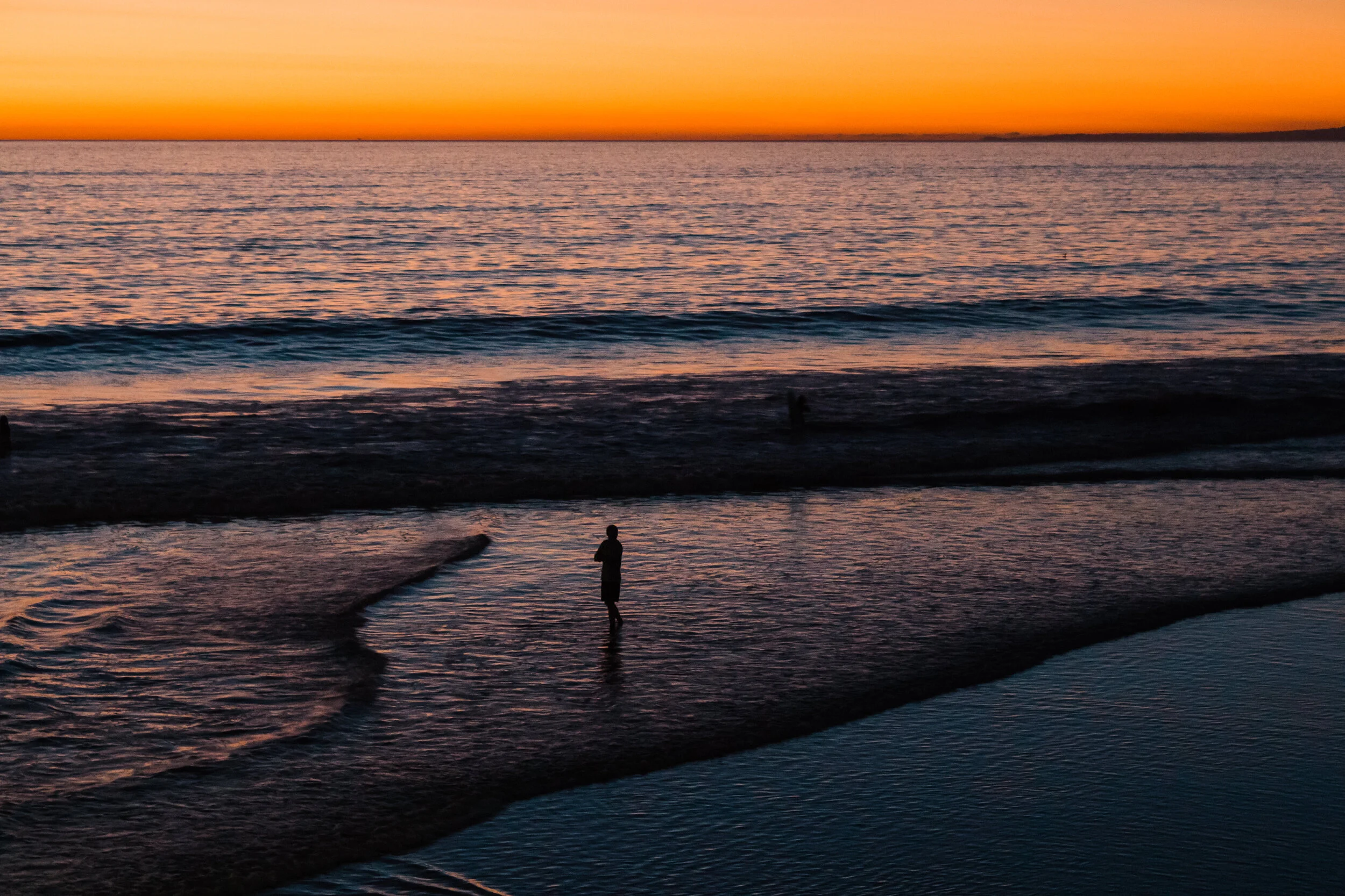 A woman takes a moment at Venice Beach, Los Angeles, USA.