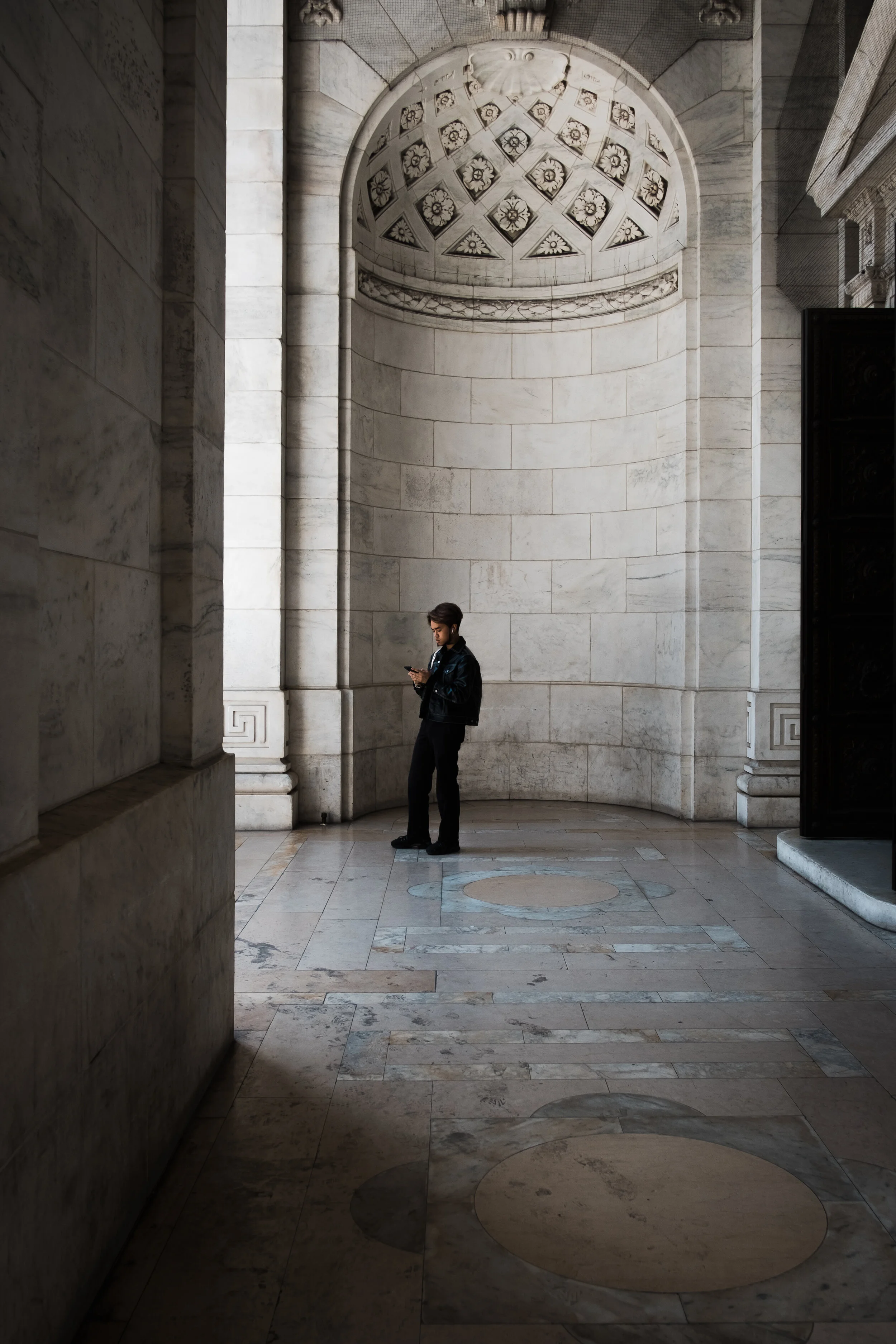 A man checks his phone at the New York Public Library in New York, USA.