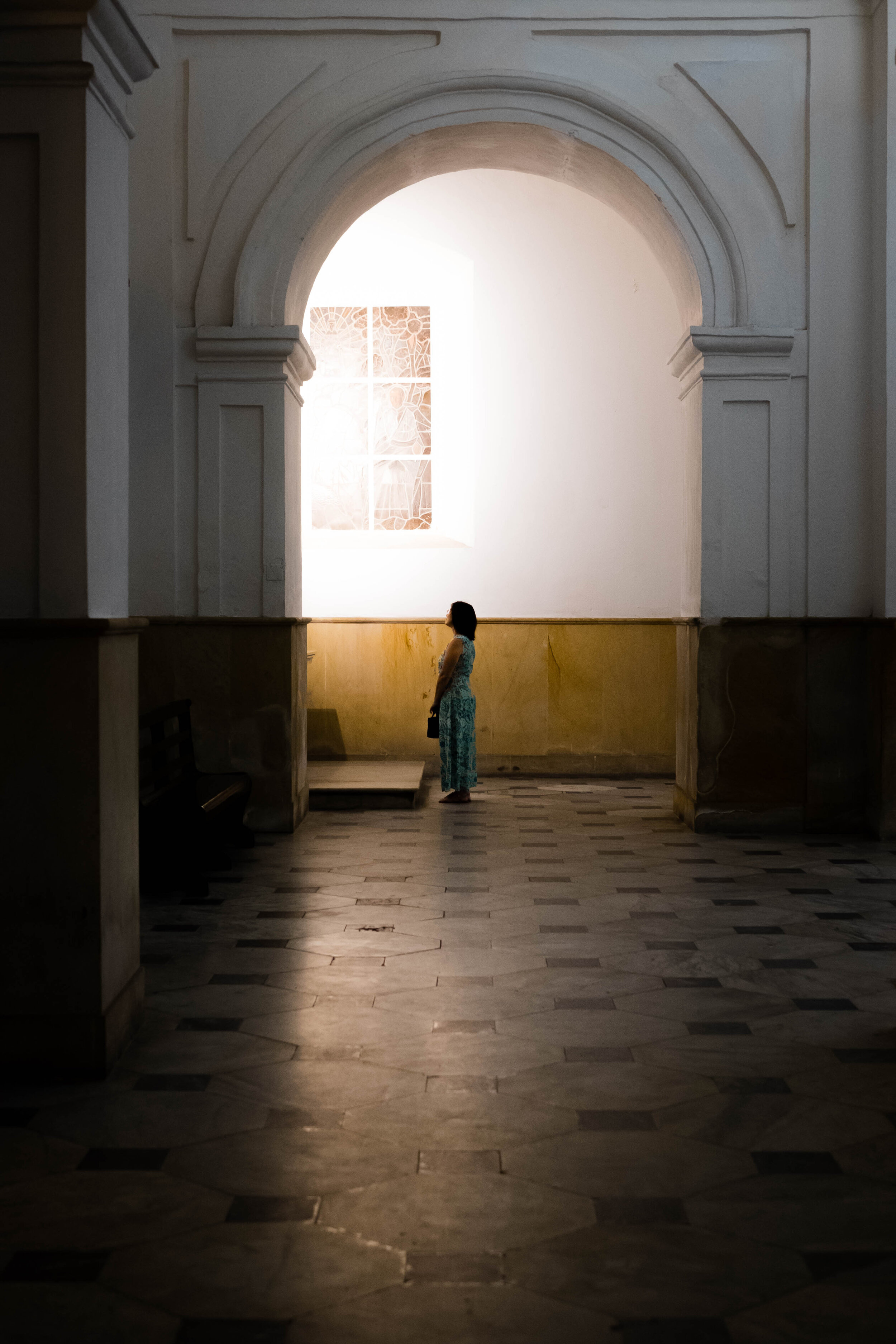 Woman in solitude. Church in Cartagena, Colombia.