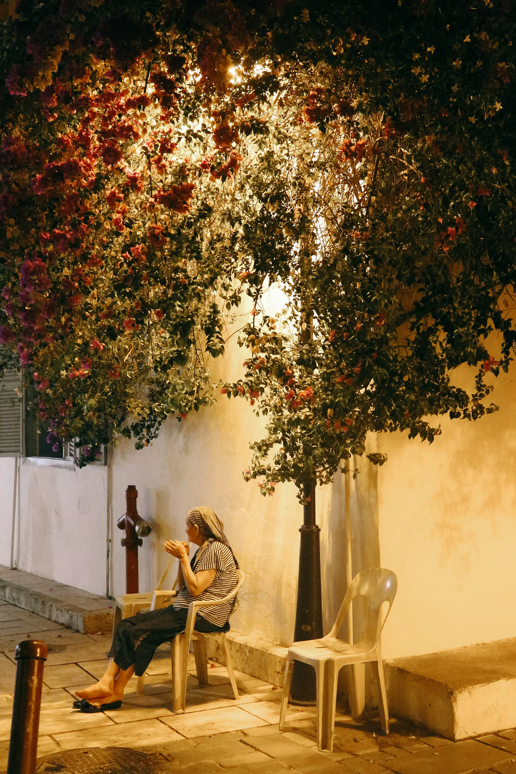 Woman sitting in front of her house in Kaleici, Antalya, Turkey.