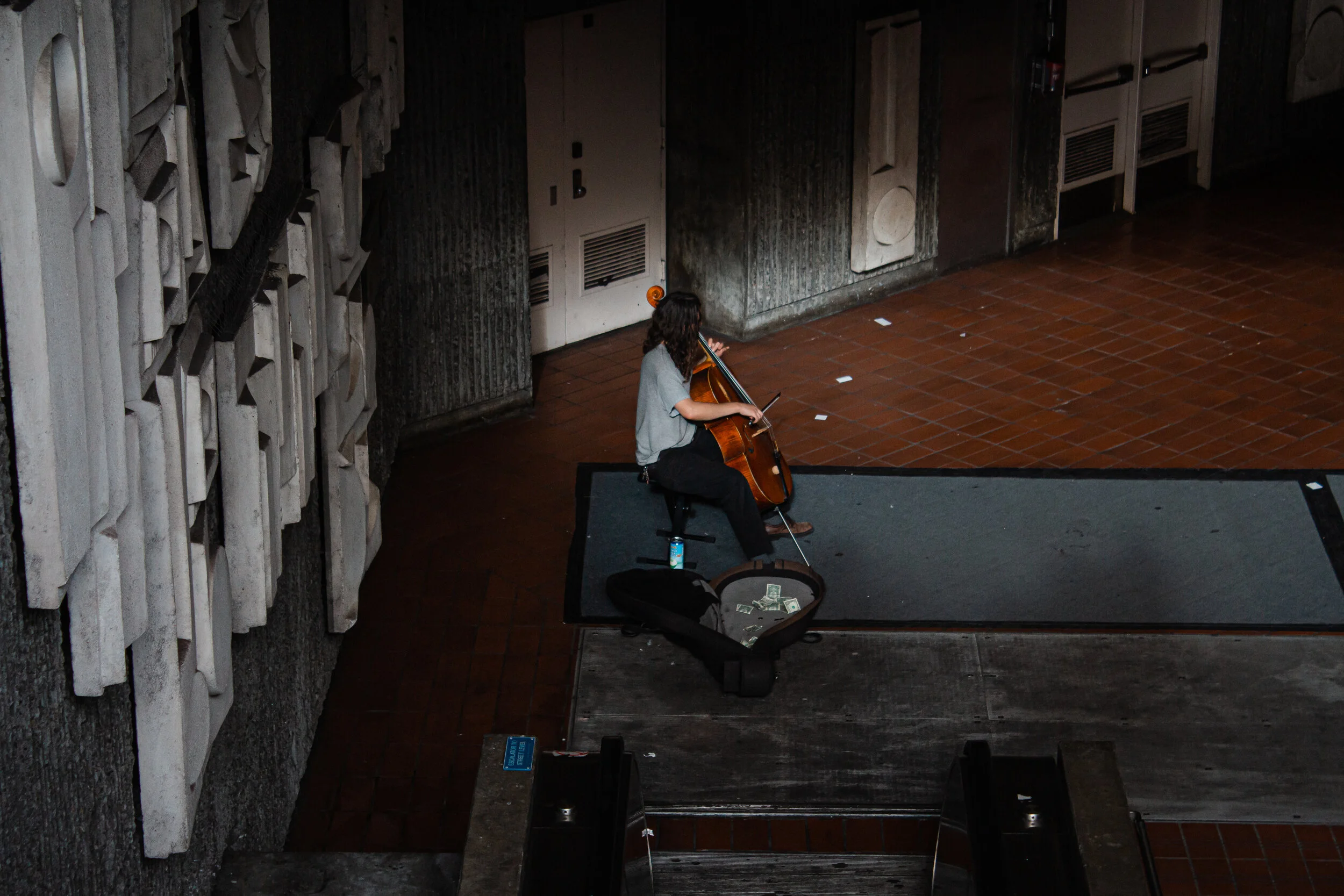 An artist playing the cello in a subway station in San Francisco, CA, USA.
