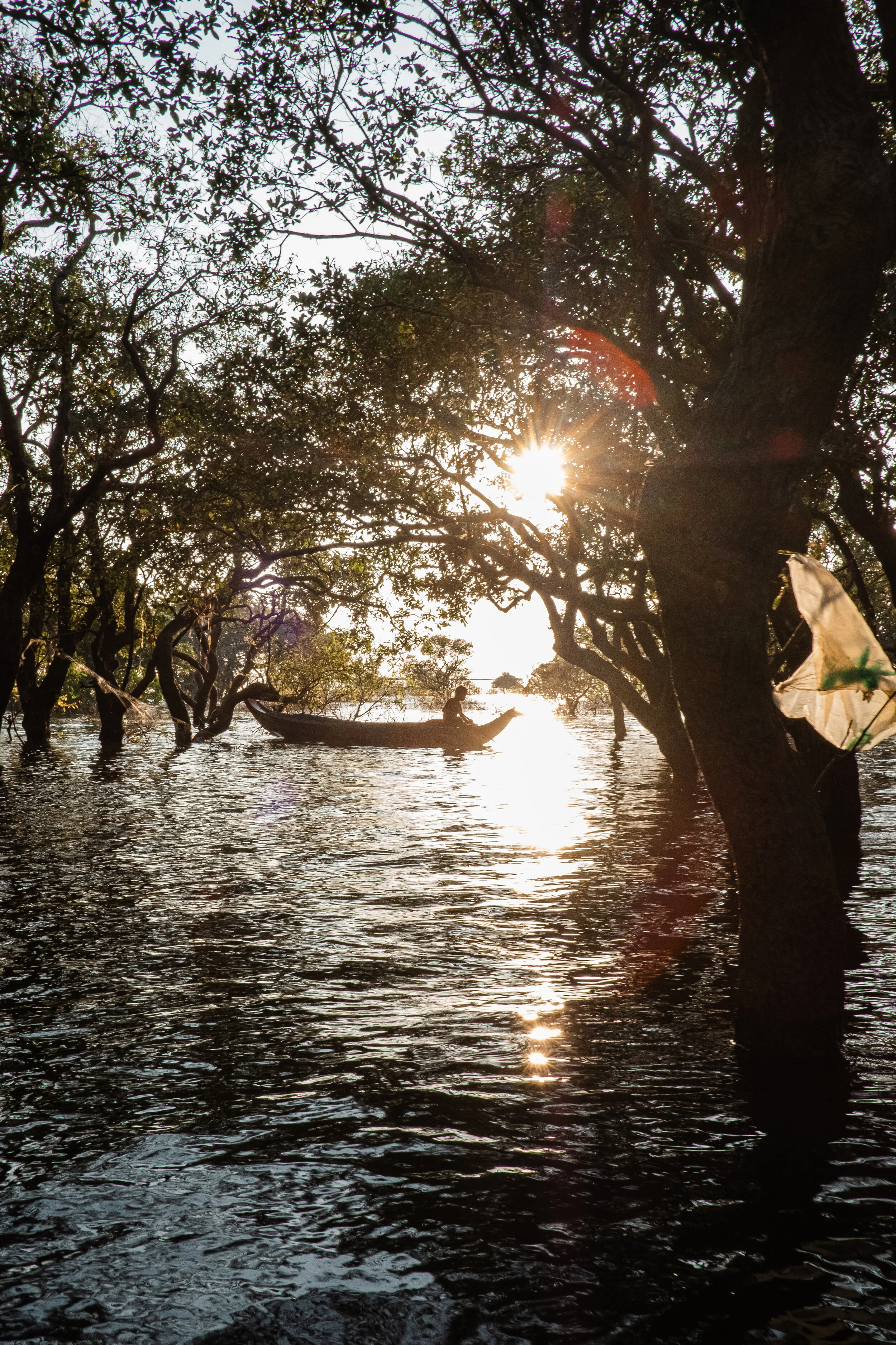 A boy steers a boat in Tonle Sap Lake in Siem Reap, Cambodia.