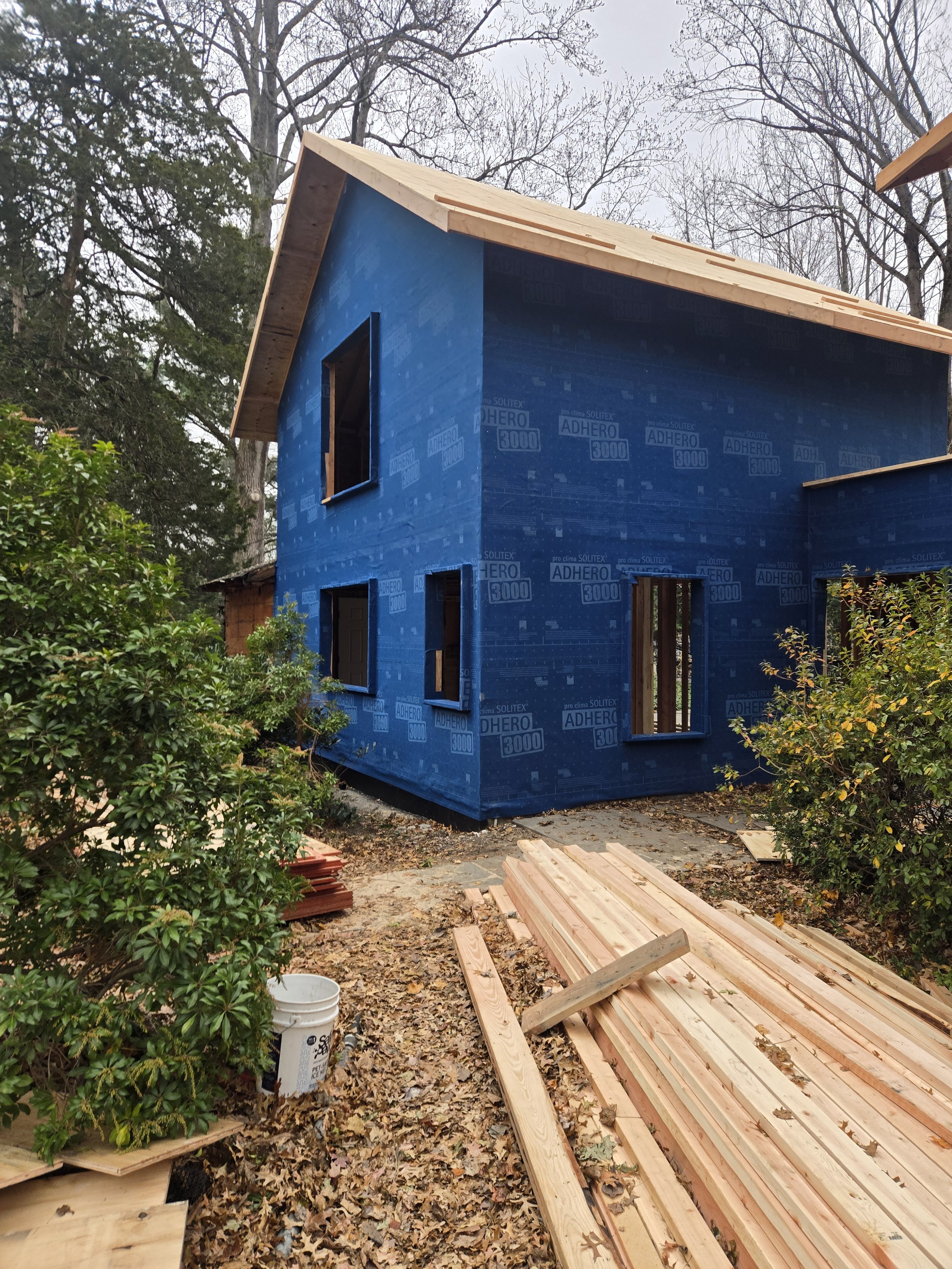 Garage addition during construction, showing new framing and weather-resistive barrier.