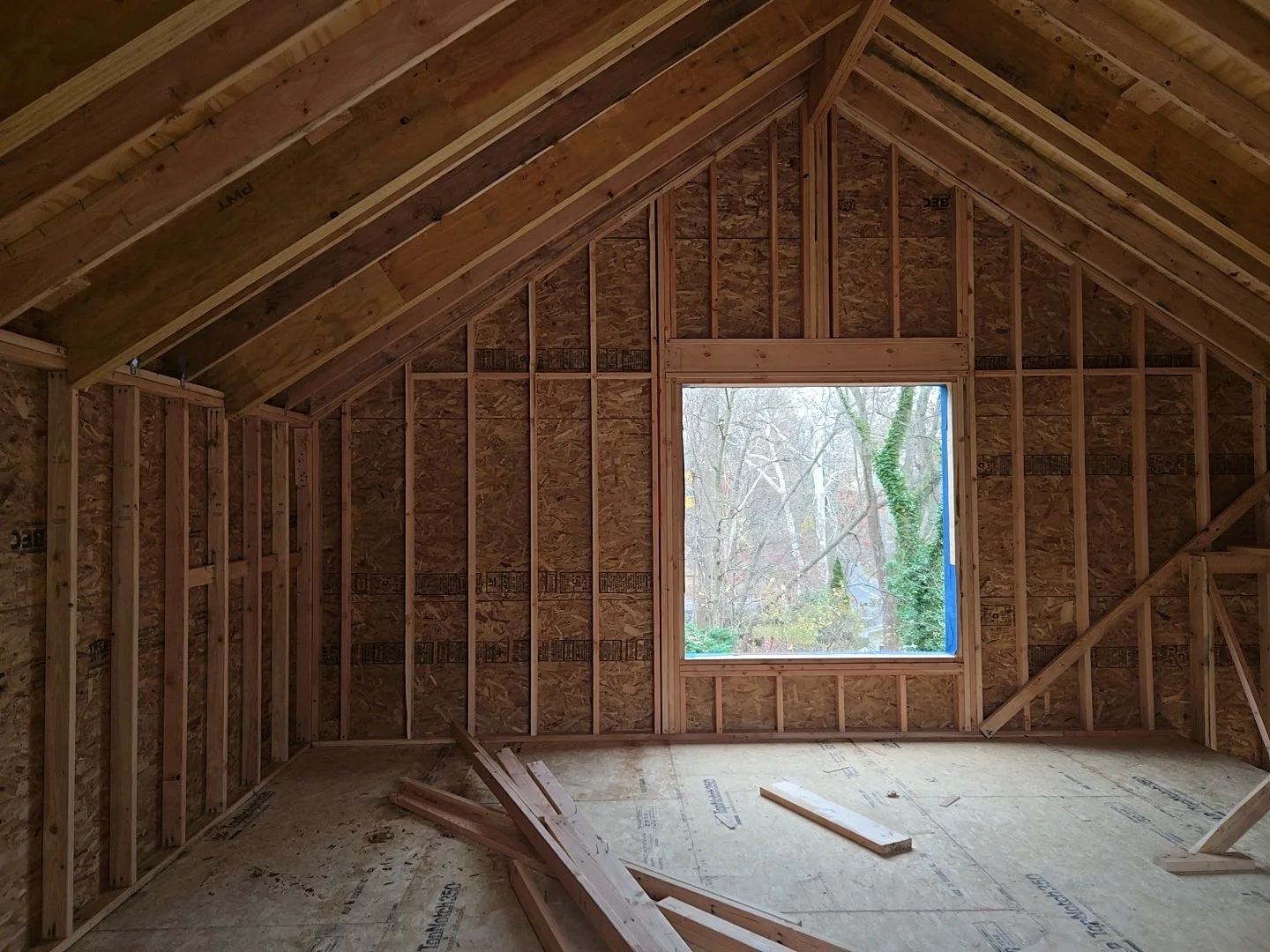 Interior view of the West Hill Residence during construction, showing framing at the new second-floor loft.