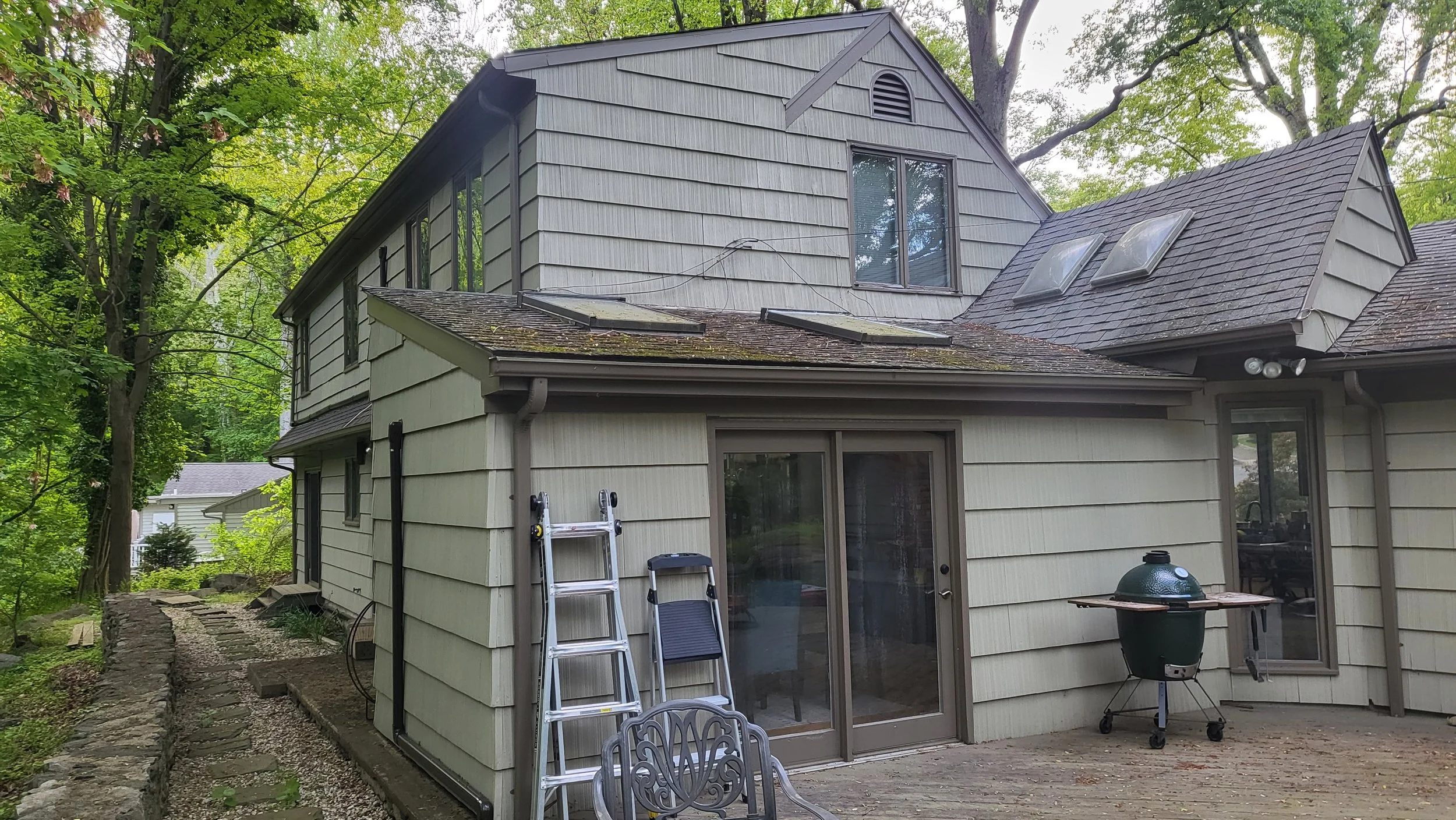Rear view of the West Hill Residence prior to renovation, showing accumulated additions and rooflines.