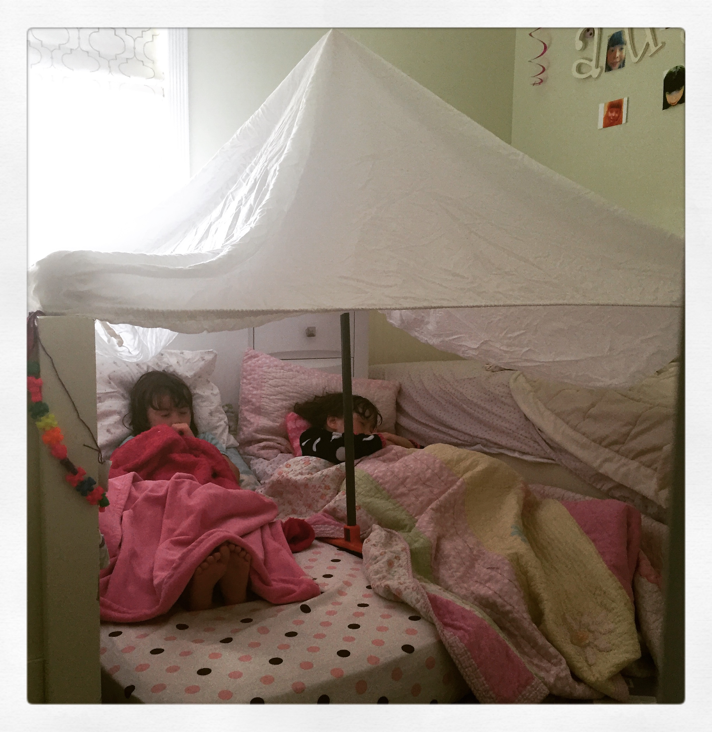 I call this "Fort Bed Knobs and Broomsticks". A cozy place for an afternoon nap or a great reading nook!
