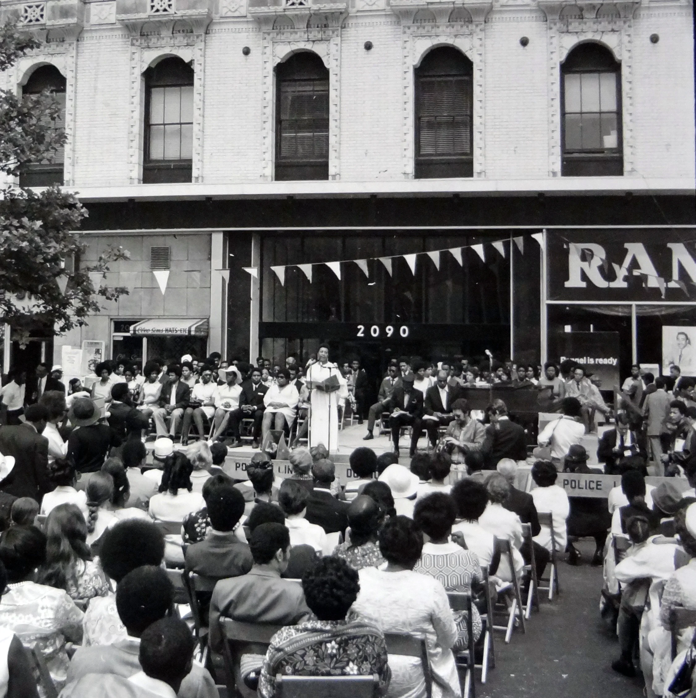 Dr. Ann Carpenter at graduation in front of Theresa Tower in Harlem.