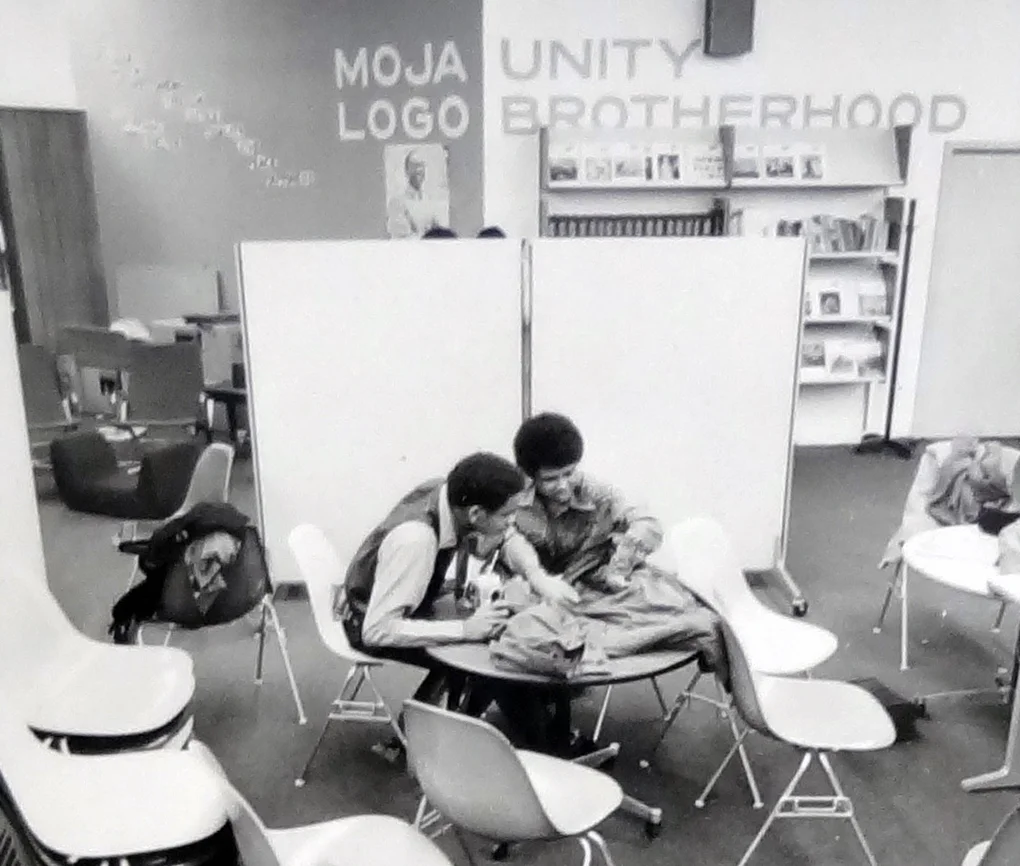 A beautiful picture — students working, with no one else in sight, under the Moja Logo slogan.
