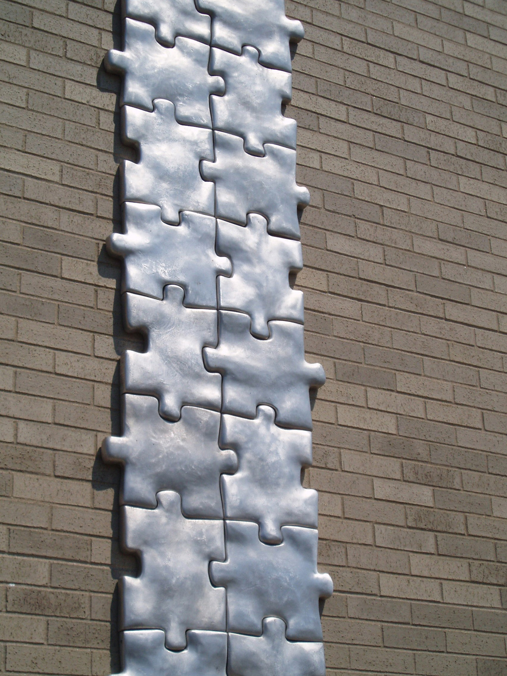 Puzzled, 1998-1999. Cast Aluminum, 432"h X 24"w X 2"d, detail. Permanent Collection Plattsburgh Sculpture Park. Myers Fine Arts Building