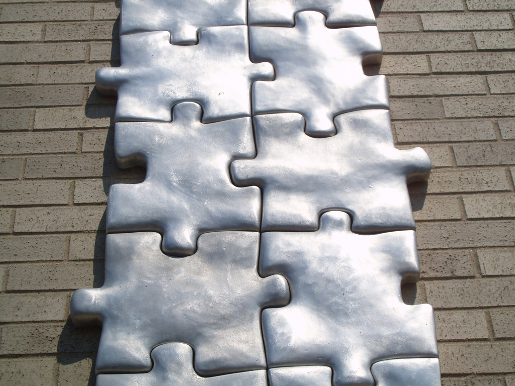 Puzzled, 1998-1999 Cast Aluminum, 432"h X 24"w X 2"d, detail. Permanent Collection Plattsburgh Sculpture Park. Myers Fine Arts Building