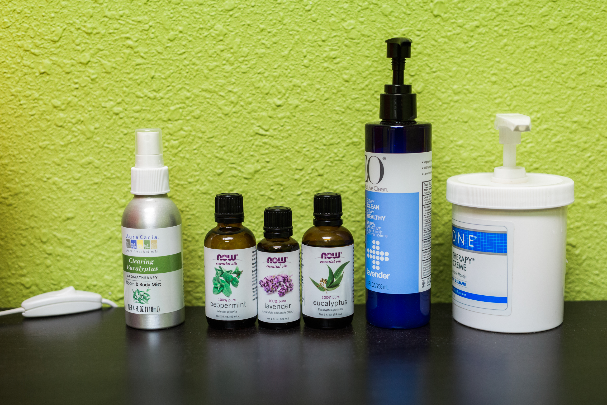  Photo showing a variety of bottles containing oils and lotions neatly arranged at Mantis Massage, located on South Congress Avenue in Austin, Texas. 