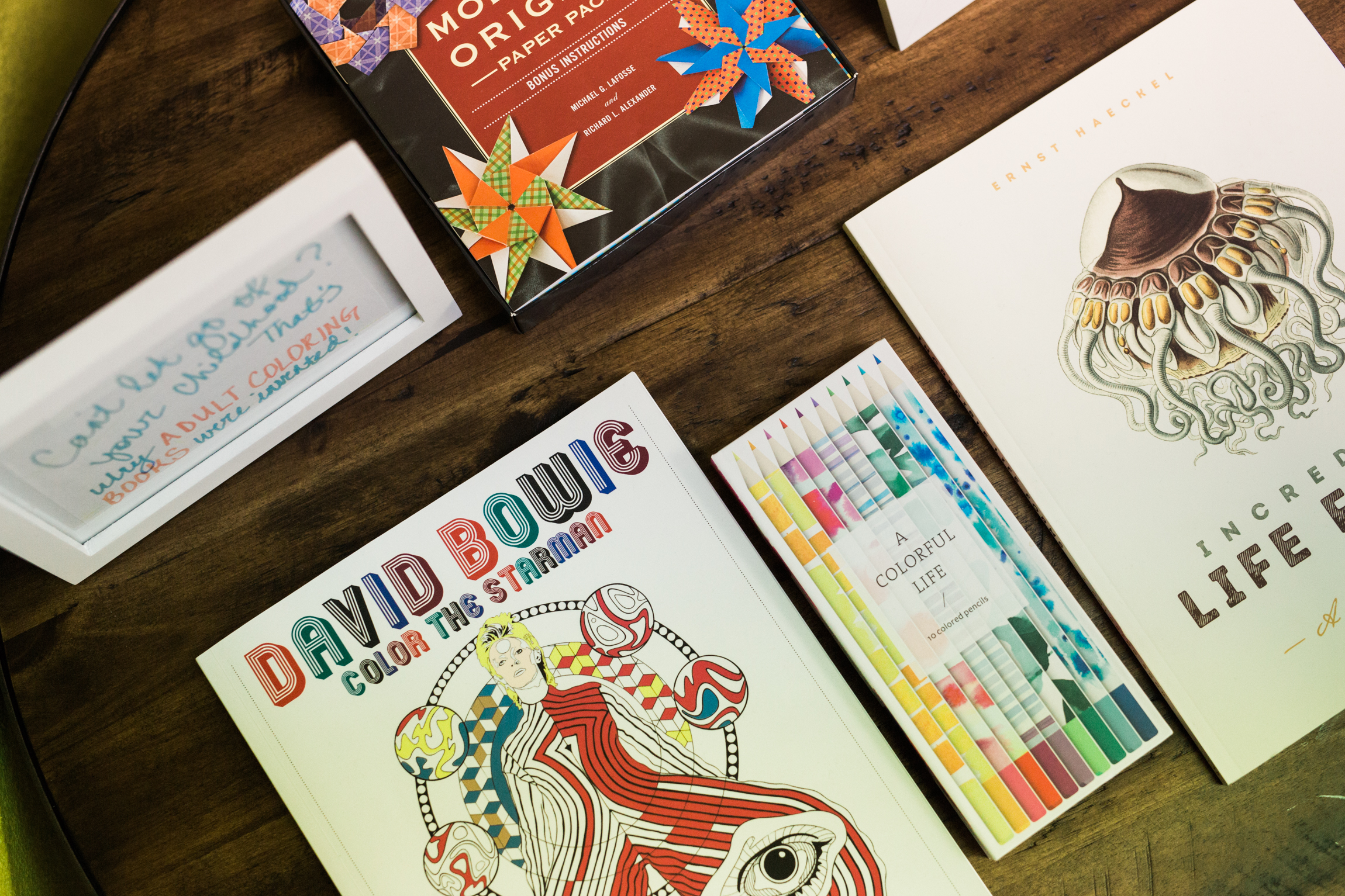  Image shows David Bowie mindfulness coloring book as well as additional therapeutic mindfulness items in the waiting area of Mantis Massage in Austin TX. Immerse yourself in creative relaxation as you await your personalized massage experience. 