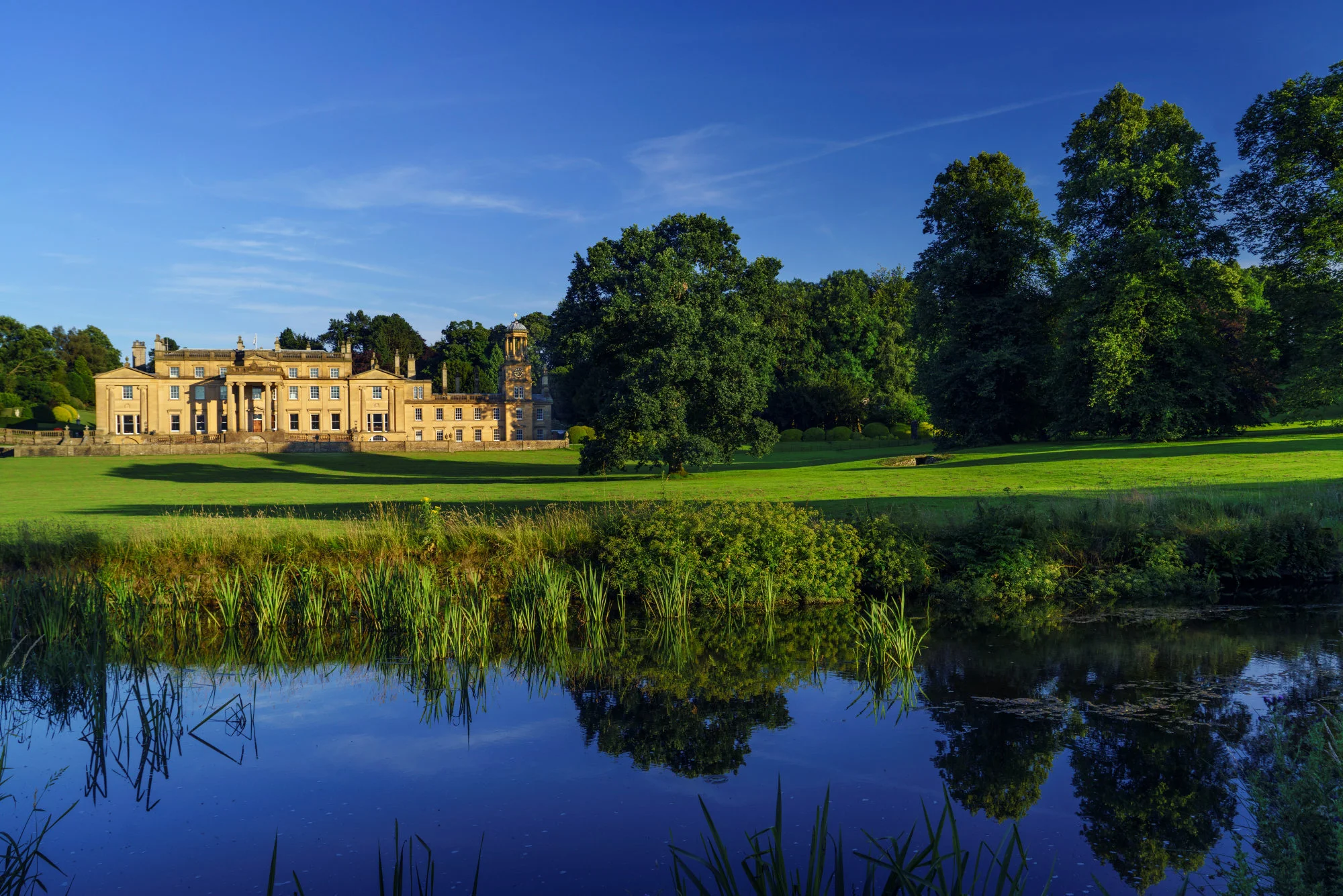 broughton-hall-front-blue-sky-reflection-water.jpg