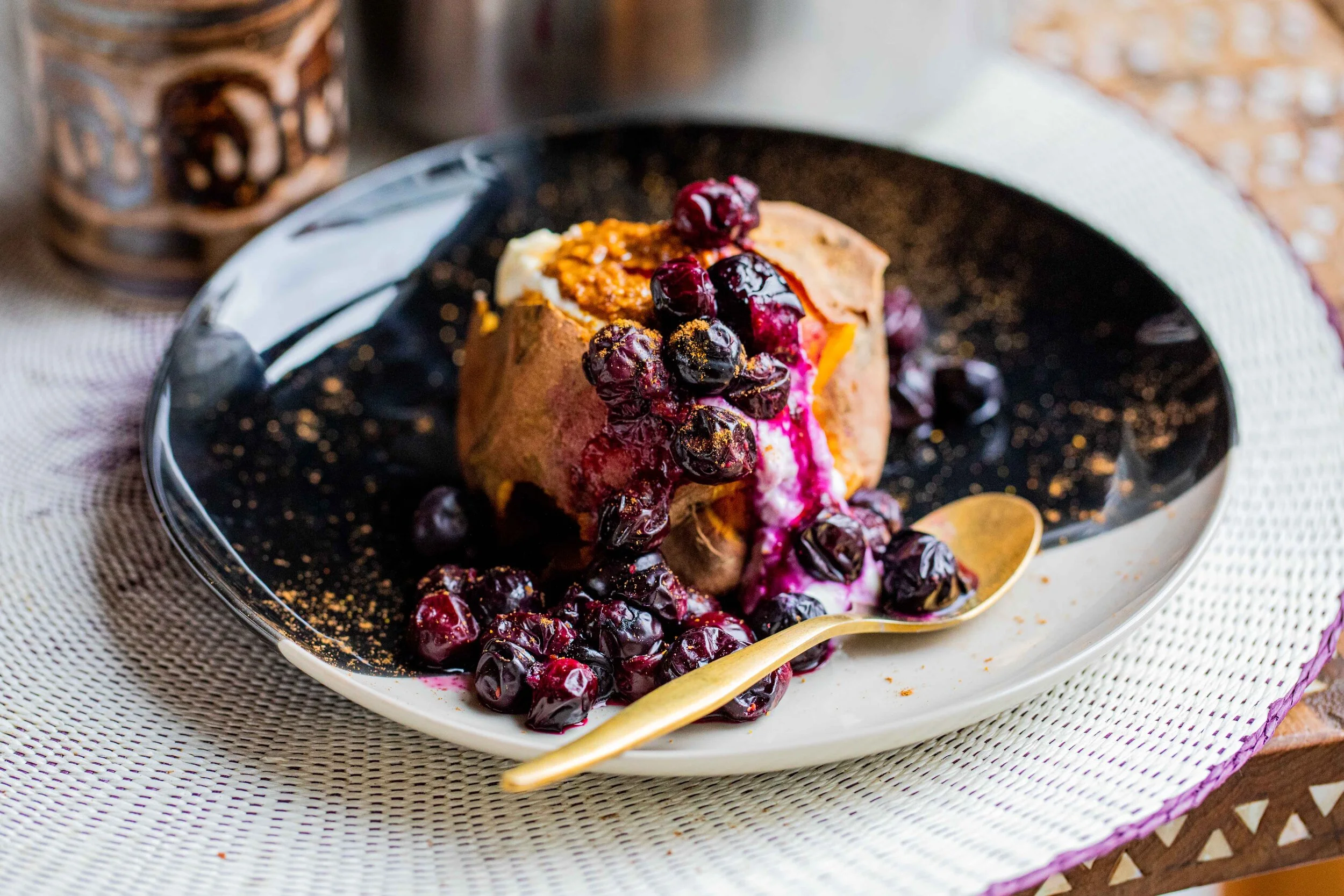 BAKED SWEET POTATO WITH ALMOND BUTTER, COCONUT YOGHURT, BLUEBERRIES AND CINNAMON