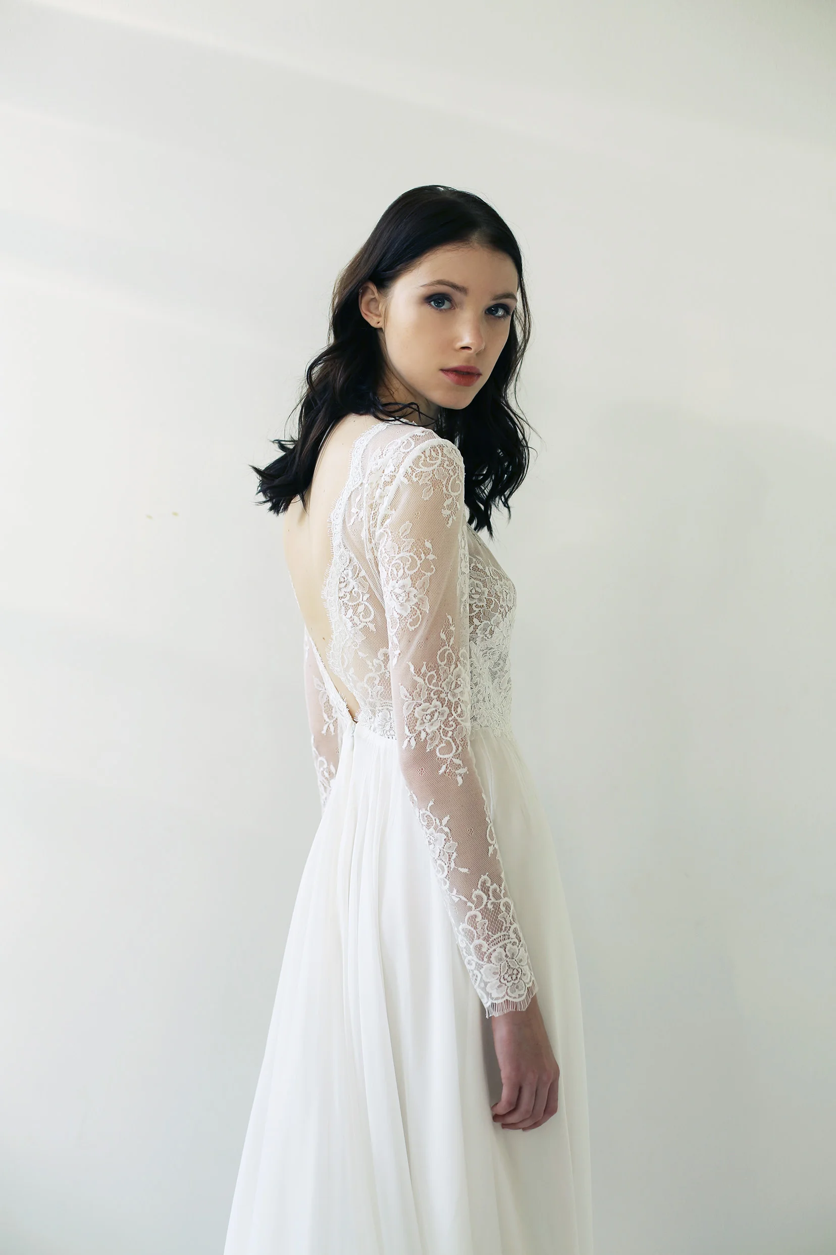 Copy of light ivory lace and silk chiffon gown with long sleeves and a deep V open back. The front of the bodice is fully lined in nude silk charmeuse