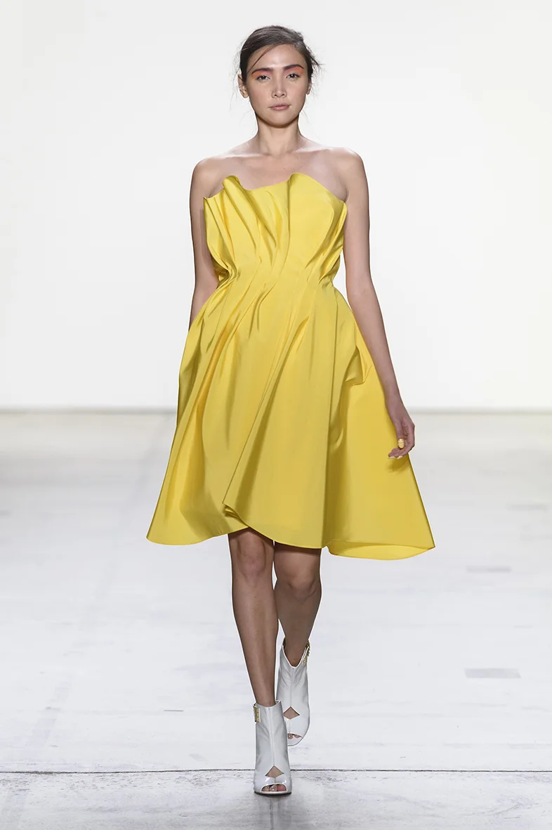 Yellow asymmetrically draped and structured silk faille cocktail dress. Fully lined in silk. Closes with zipper up the back.