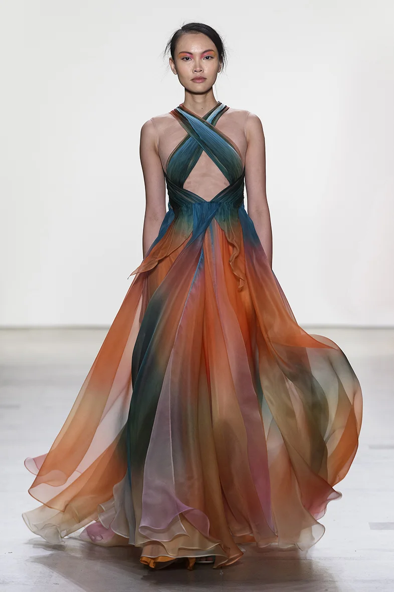Tropical sunset printed silk organza gown with draped bodice over nude illusion netting, full A-line gown with layers of silk. Fully lined in charmeuse. Closes with zipper up the back. 
