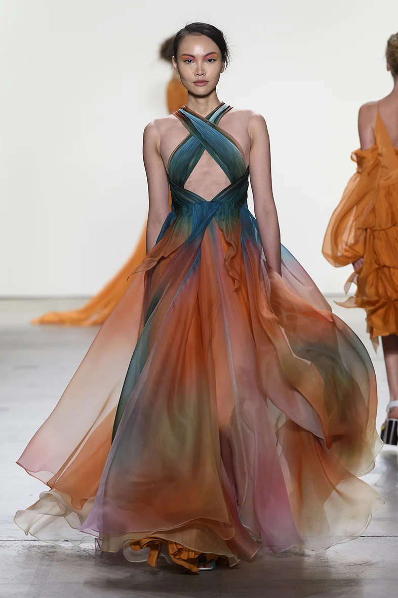 Tropical sunset printed silk organza gown with draped bodice over nude illusion netting, full A-line gown with layers of silk. Fully lined in charmeuse. Closes with zipper up the back. 