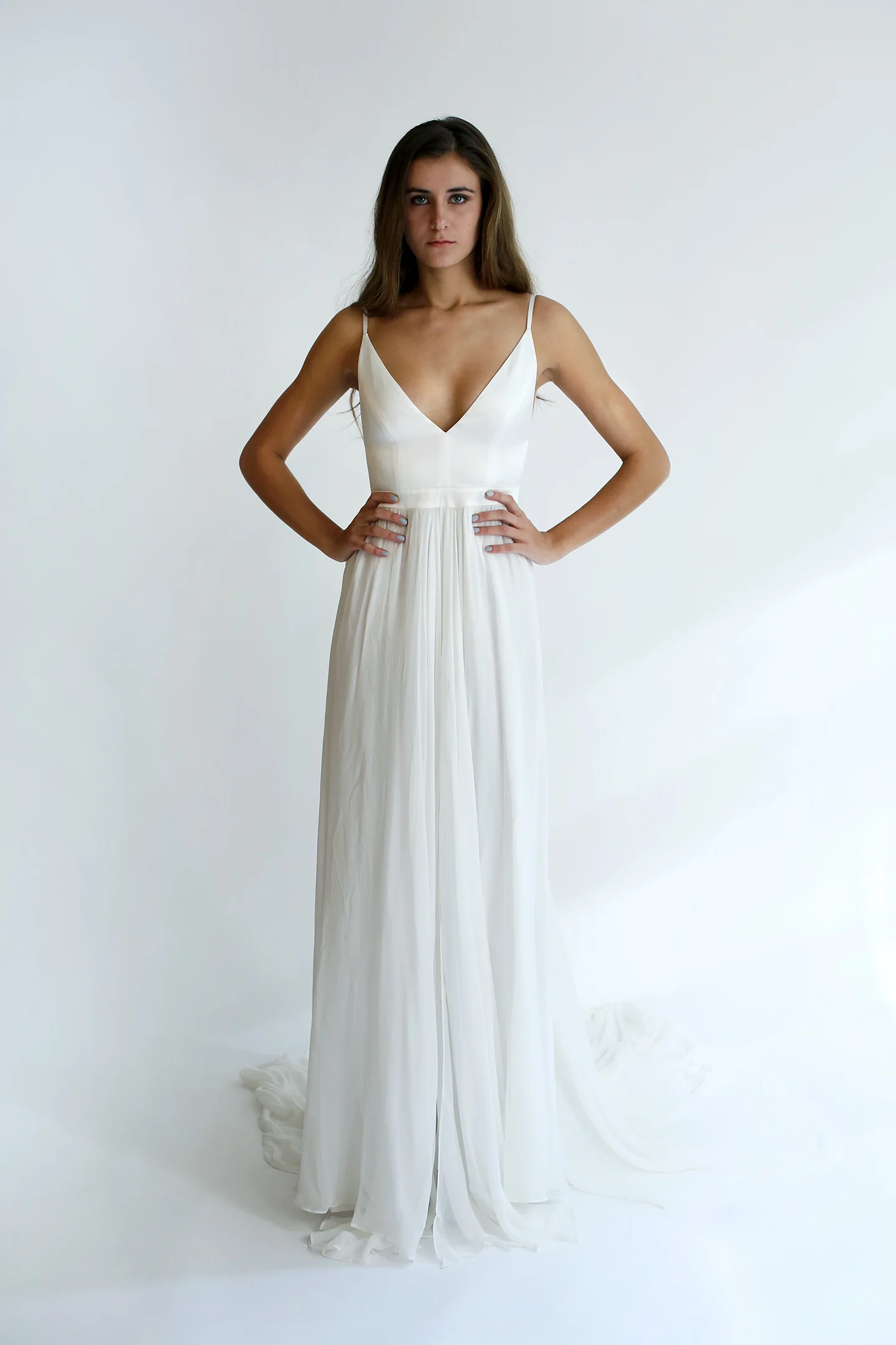 V-neck gown with lined silk- charmeuse bodice and wide-open back, and softly gathered silk chiffon skirt with slit opening at center front and long train in the back