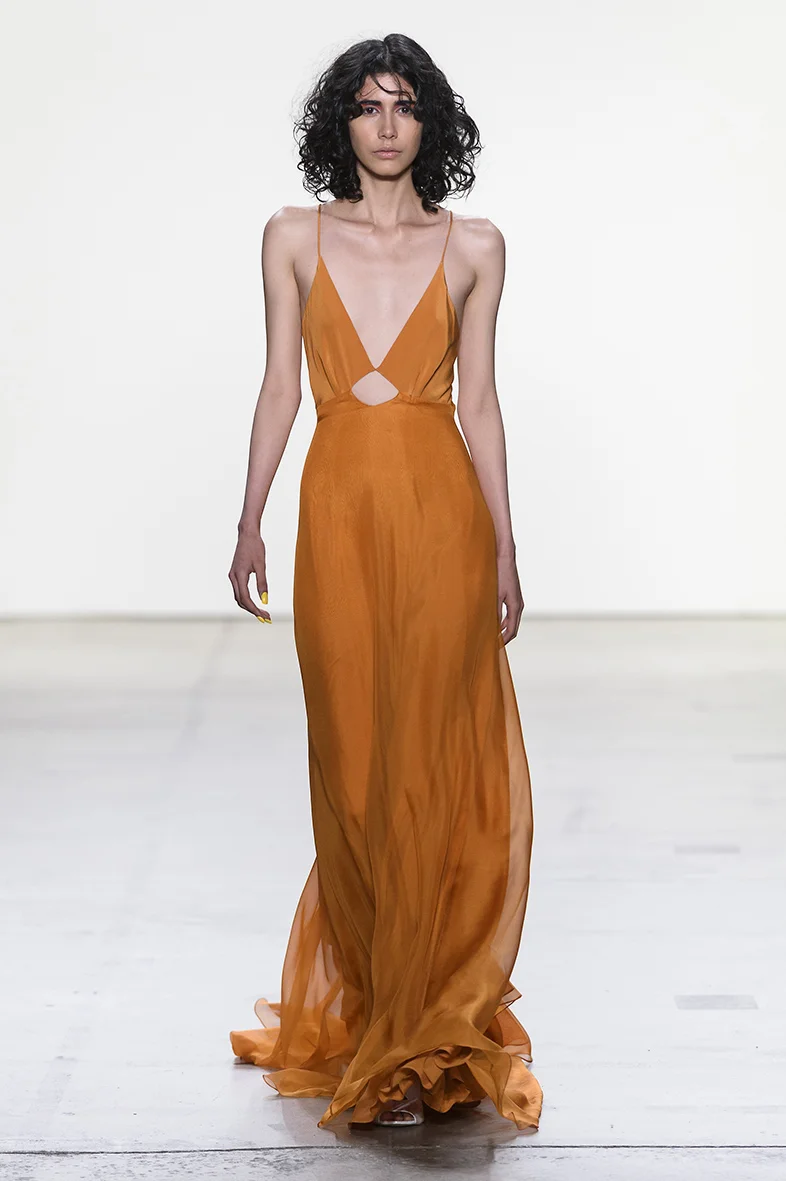 Orange V neck tiered gown in silk chiffon with low cut out back. Invisible zipper up the back. Fully lined in silk.