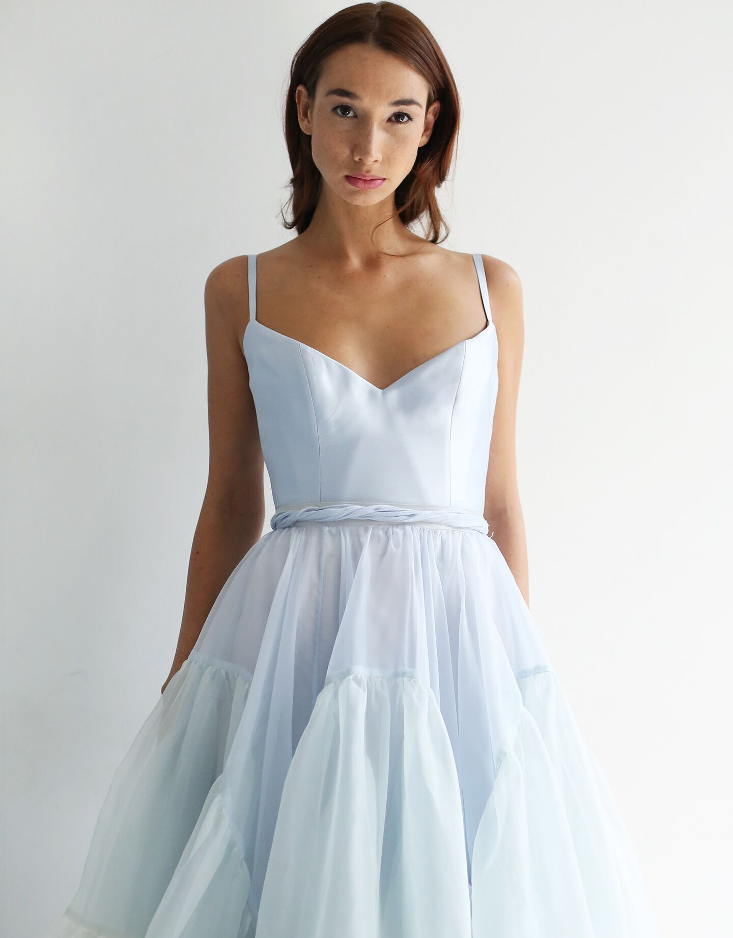 Boned silk twill bodice with V neck and adjustable straps, button back closure, with inner elastic/hook. Extends about 1.5" below natural waist.