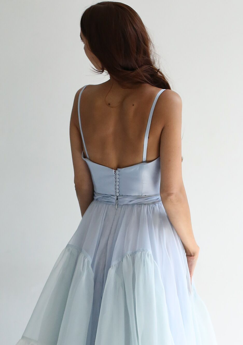 Boned silk twill bodice with V neck and adjustable straps, button back closure, with inner elastic/hook. Extends about 1.5" below natural waist.