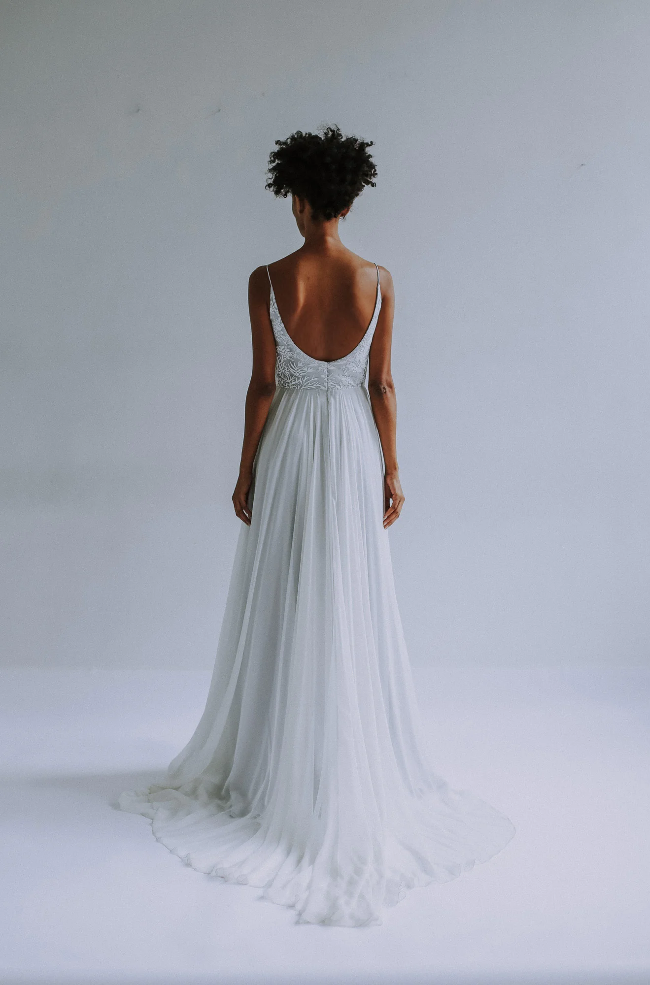 Ivory lace layered over gray-blue lining and foundation.. Bodice has rounded scoop neckline with spaghetti straps, Full A-line skirt in silk chiffon. Closes with zipper up the back.