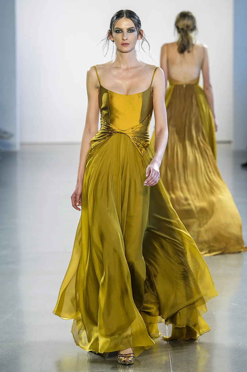 Rich, deep gold silk gown with scoop neck bodice and full A-line silk chiffon skirt. twisted detail at waist. Dress fully lined in silk.
