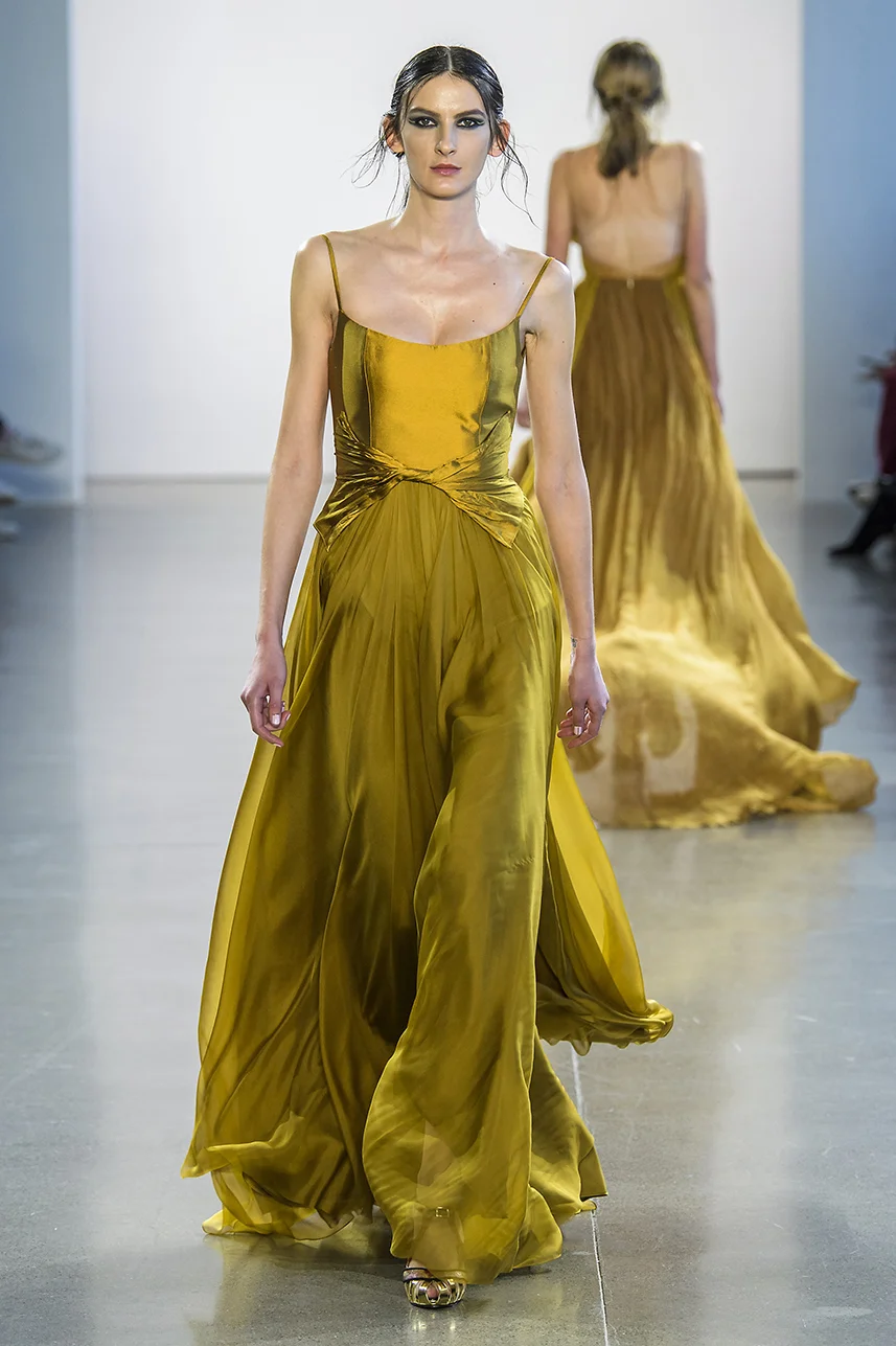 Rich, deep gold silk gown with scoop neck bodice and full A-line silk chiffon skirt. twisted detail at waist. Dress fully lined in silk.