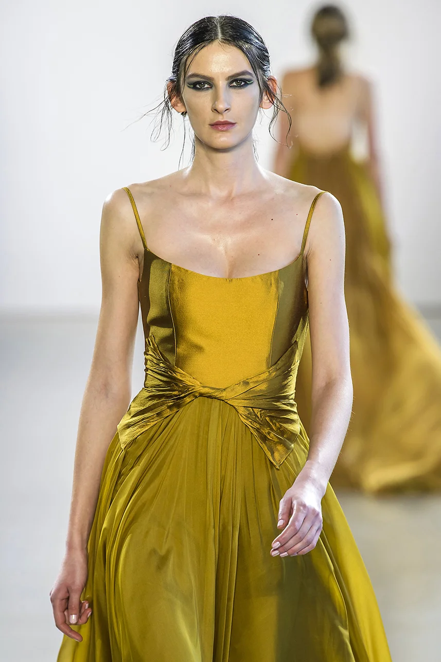 Rich, deep gold silk gown with scoop neck bodice and full A-line silk chiffon skirt. twisted detail at waist. Dress fully lined in silk.