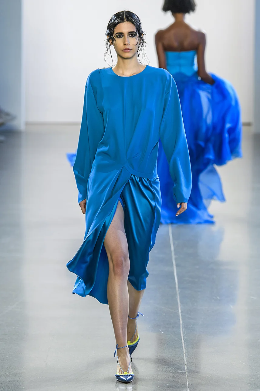 Rich silk crepe dress with draped overlap skirt detail. Easy fit, with long sleeves. Adjustable tie detail at cuffs and skirt. Shine contrast on skirt panel.
