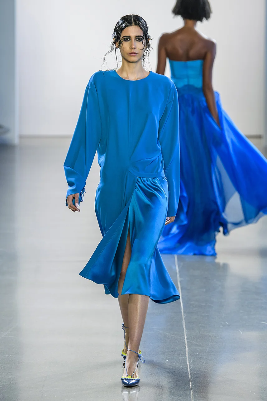Rich silk crepe dress with draped overlap skirt detail. Easy fit, with long sleeves. Adjustable tie detail at cuffs and skirt. Shine contrast on skirt panel.