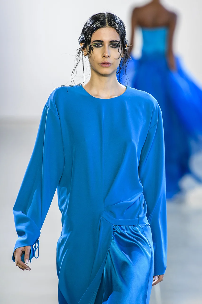 Rich silk crepe dress with draped overlap skirt detail. Easy fit, with long sleeves. Adjustable tie detail at cuffs and skirt. Shine contrast on skirt panel.