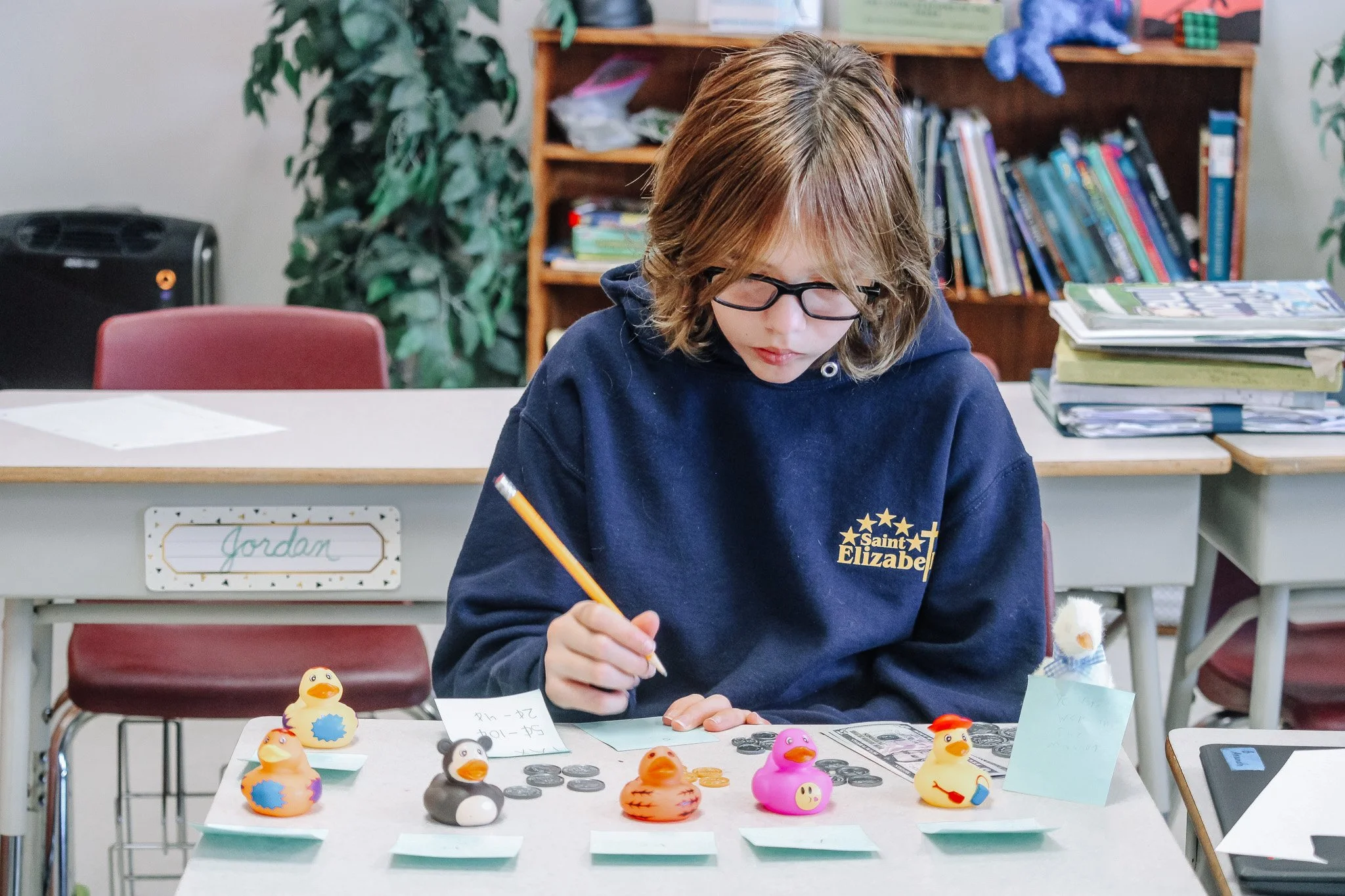Students in Ms. Fraser's Fifth Grade Math opened shops, selling goods and balancing shop ledgers. As students practiced with money and adding and subtracting decimals, they bought and sold goods, producing receipts and balancing their income and spen