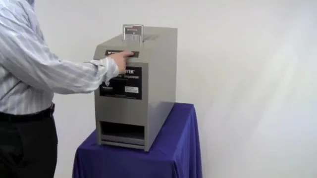 Pressing the degauss button on a slot-style deguasser