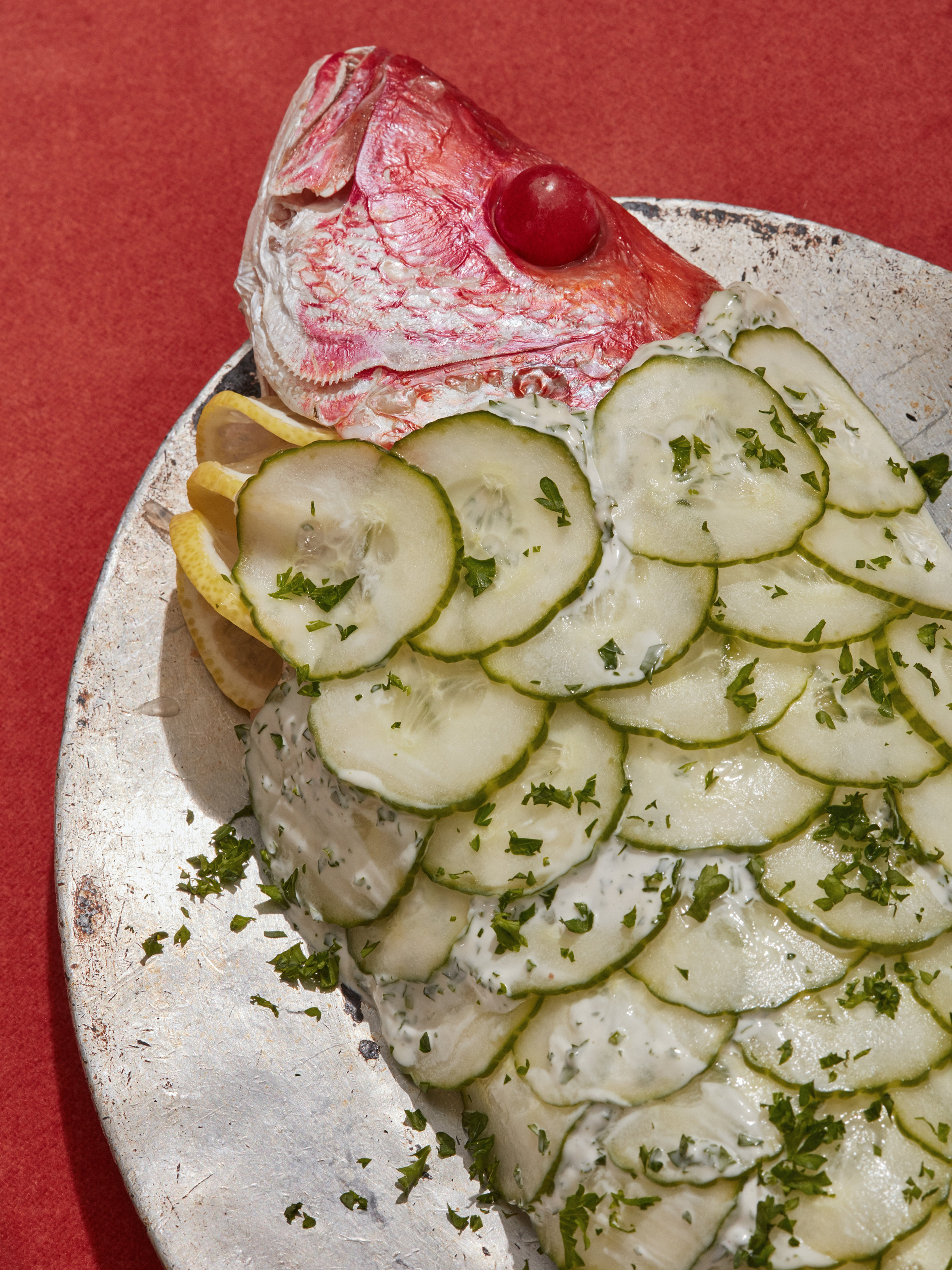 1960s Holiday Excess (insert), FT Magazine. A closeup of a roasted fish with cucumbers on top.