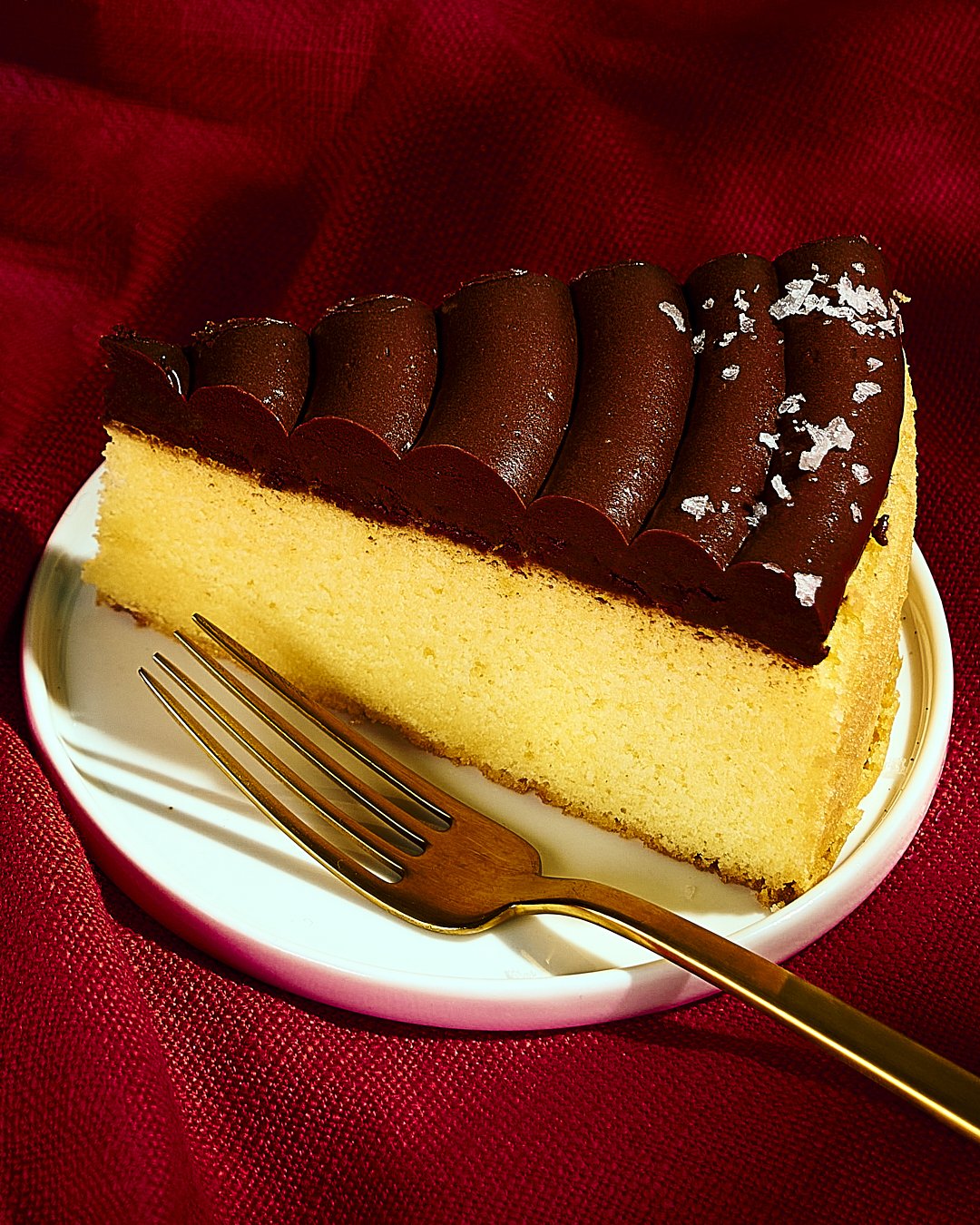 A perfect slice of yellow cake with salted ganache frosting