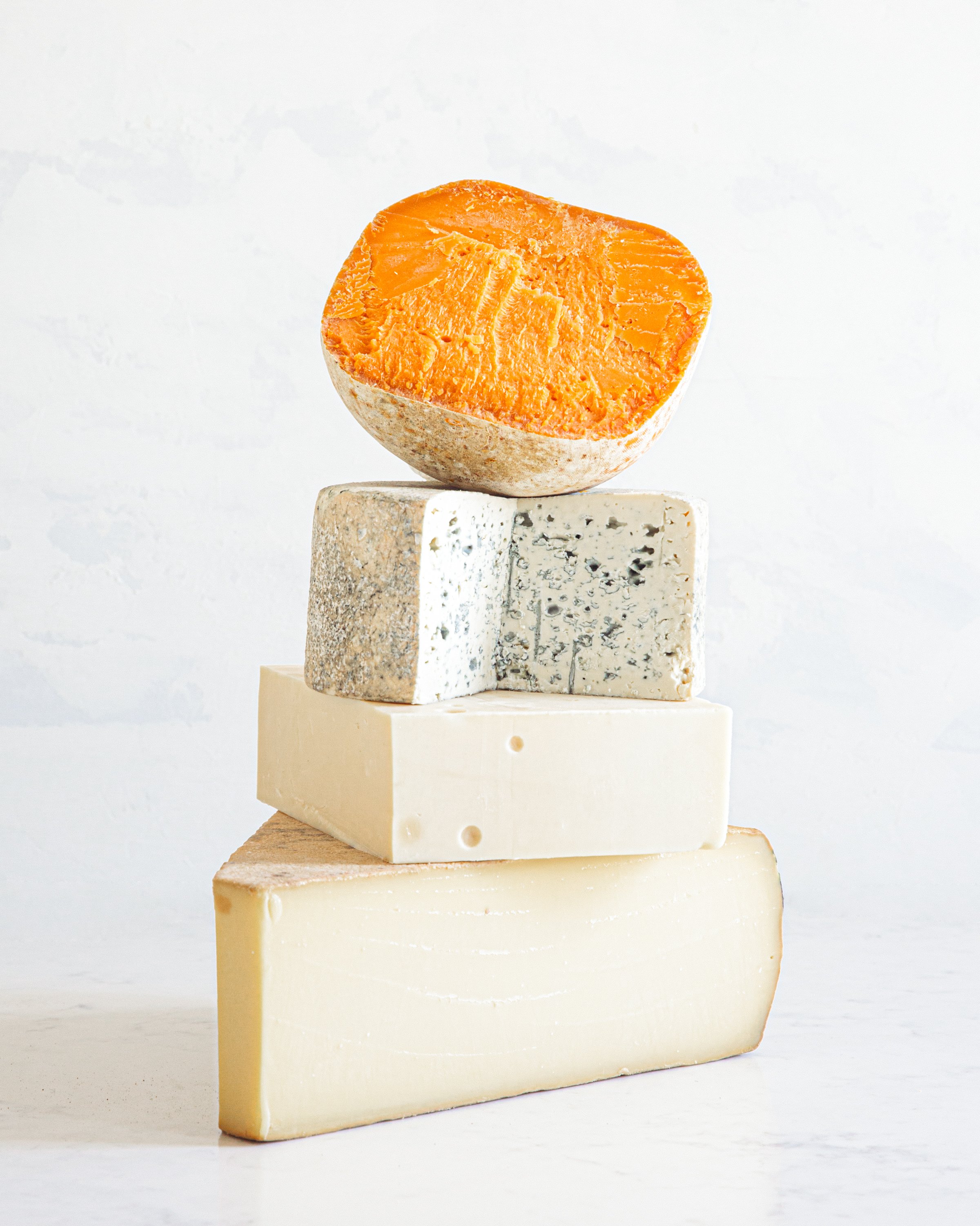 A stack of four types of cheese